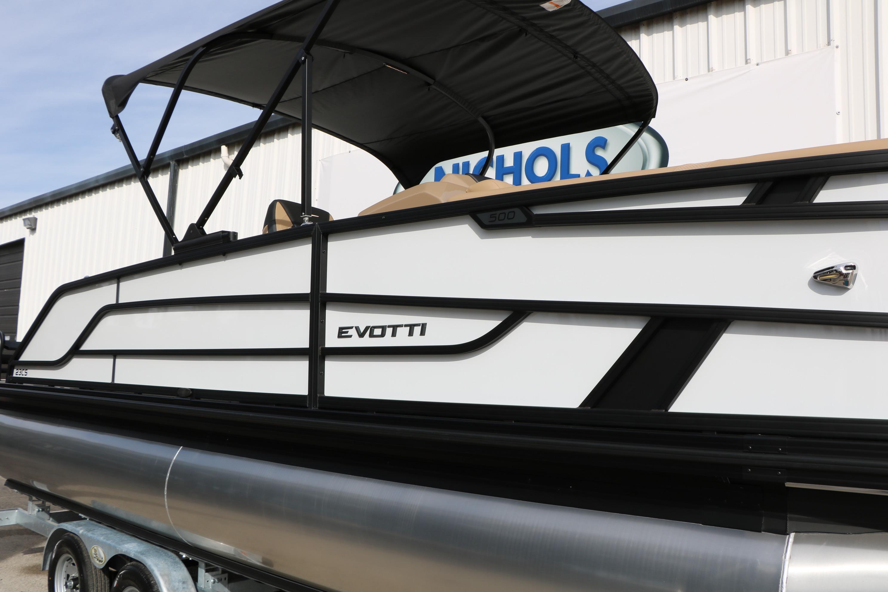2026 Evotti 523CS pontoon boat with sleek design and canopy, displayed outdoors.