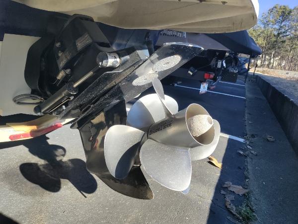 Close-up of 2005 Sea Ray 240 SD boat propeller in a parking lot.
