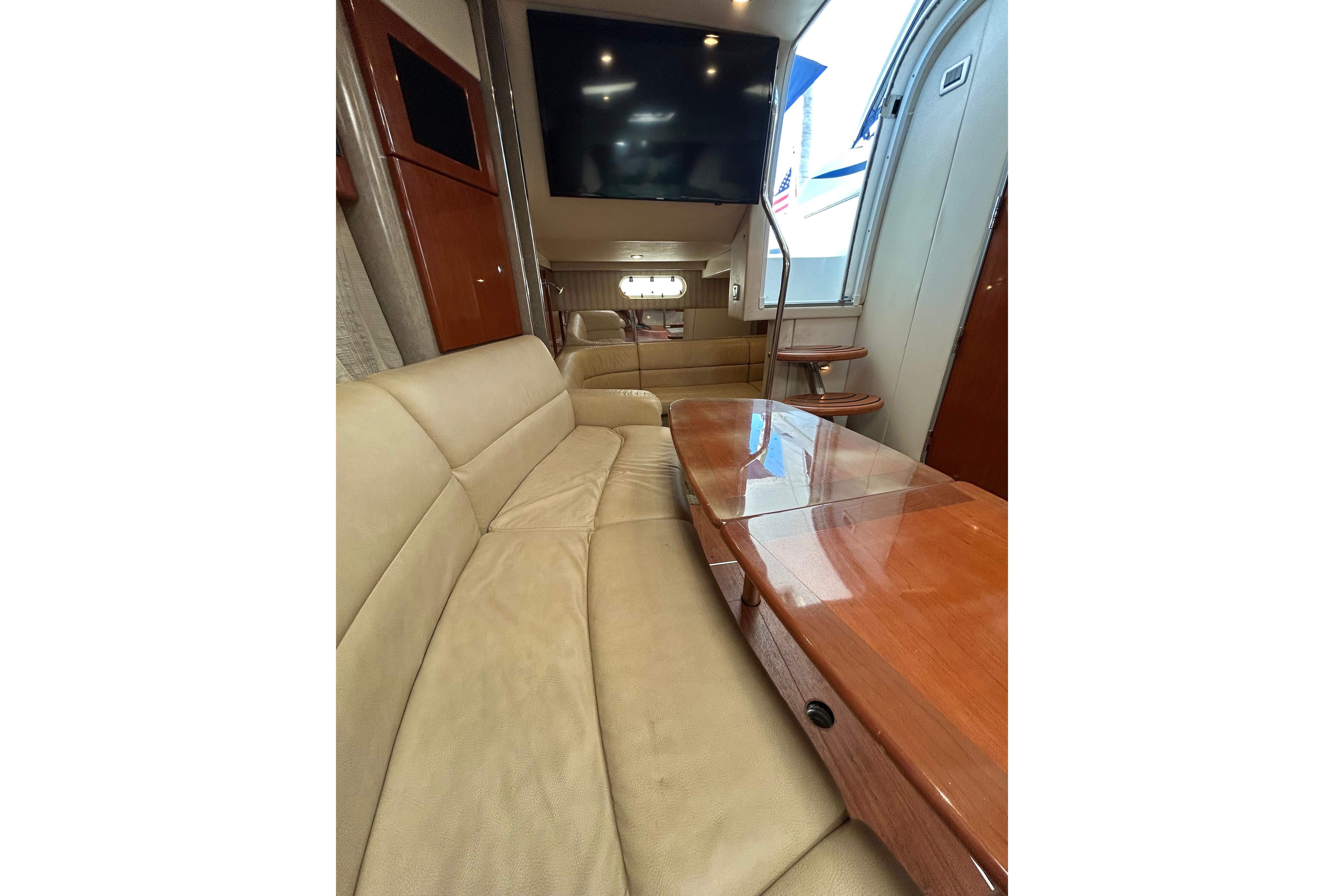 2008 Formula 34 Performance Cruiser interior with beige seating and wooden table.