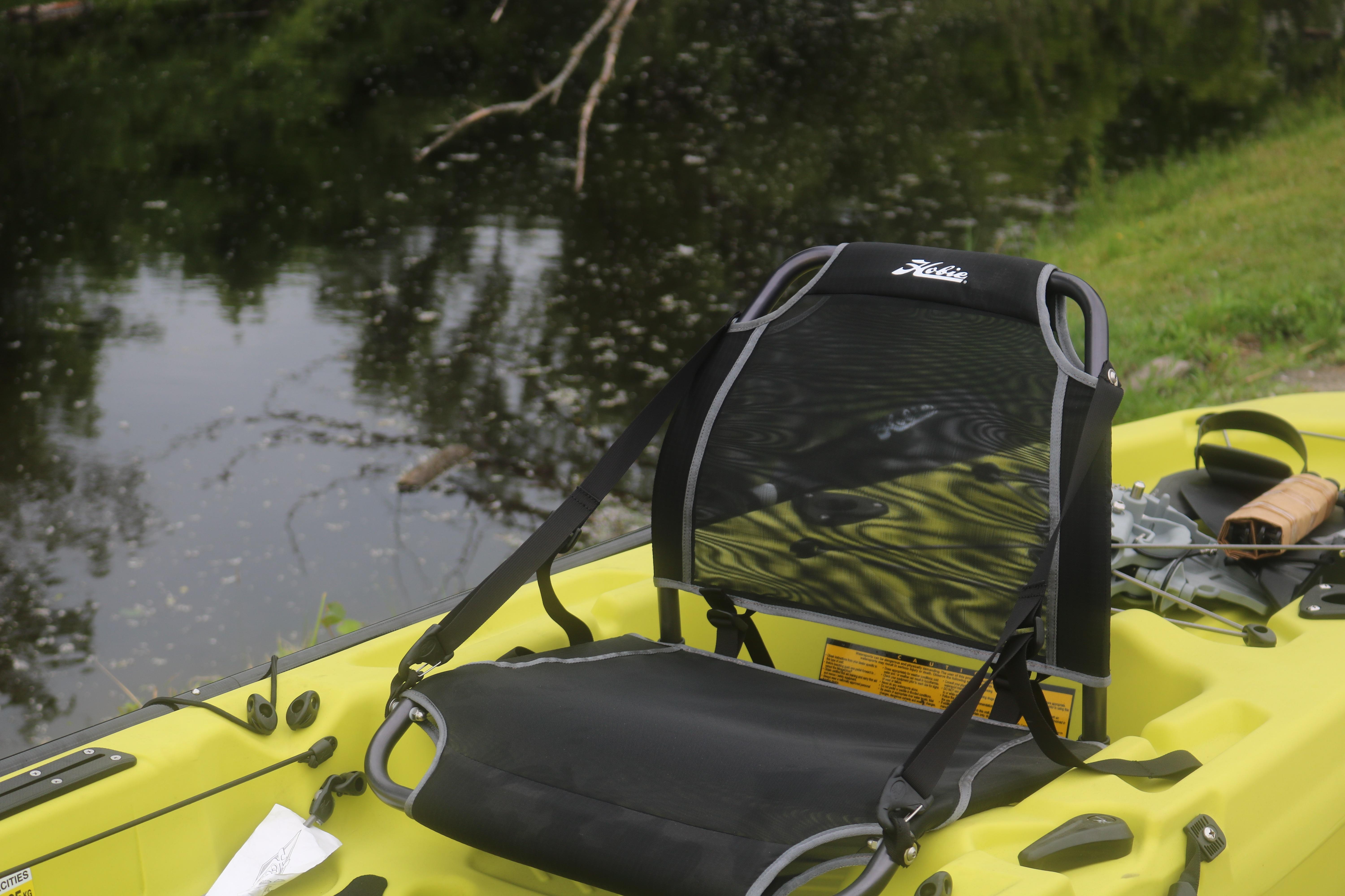 Yellow Hobie Mirage Passport 12.0 R kayak seat by a calm river, 2025 model.