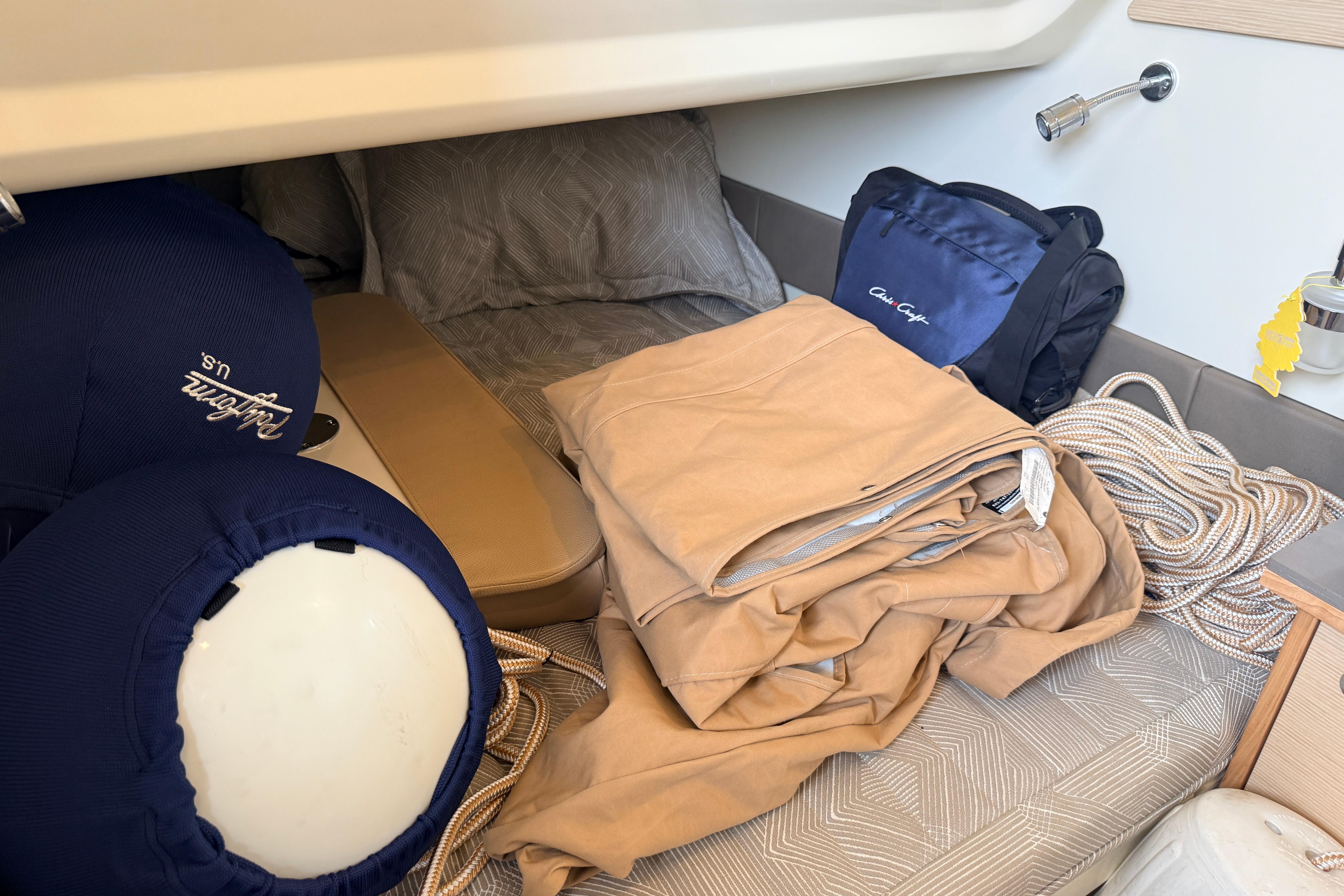 Interior of 2024 Chris-Craft Catalina 30 with cushions, ropes, and storage bags.