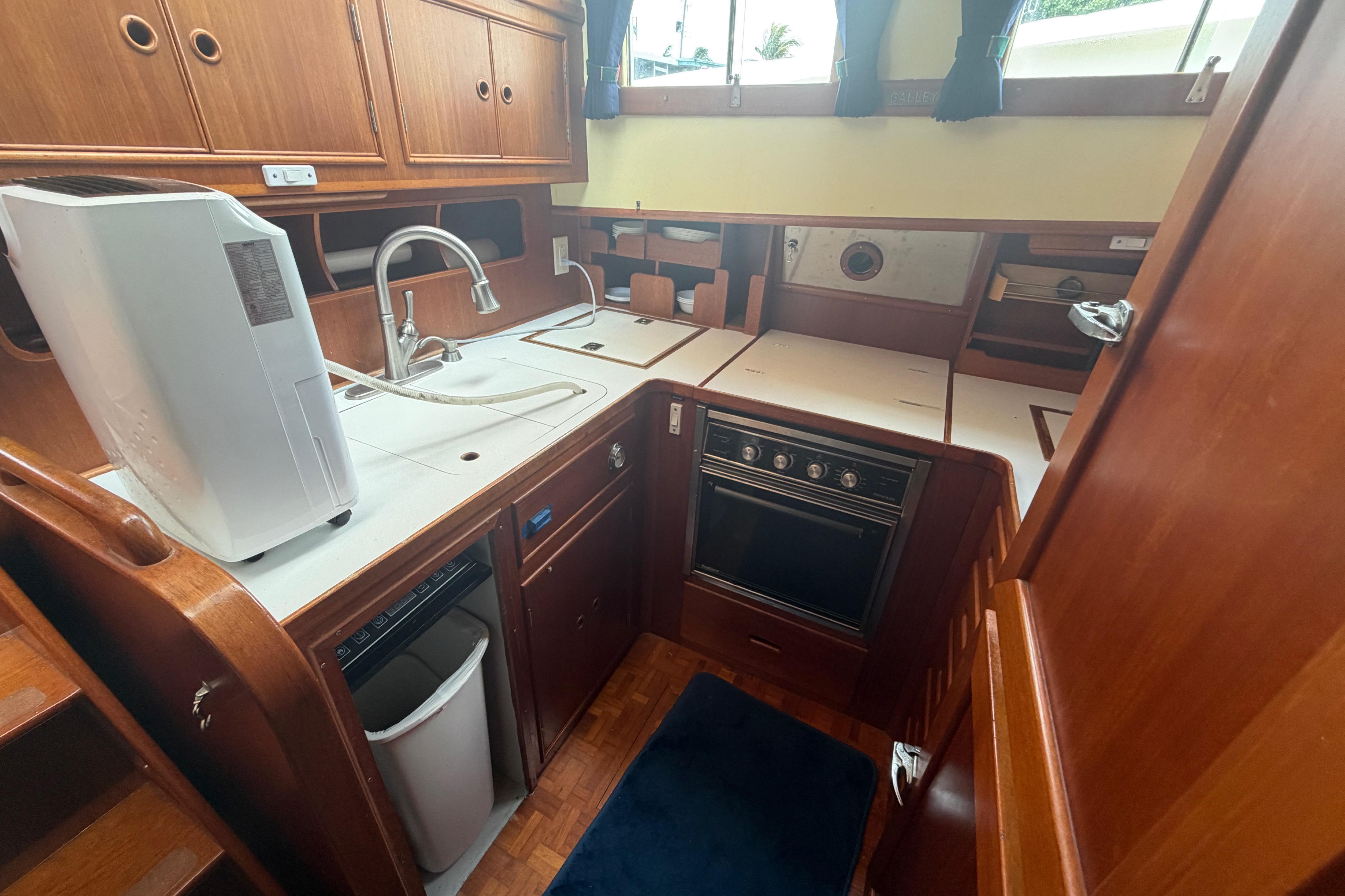 1991 Grand Banks 46 Classic yacht kitchen with wooden cabinetry and modern appliances.