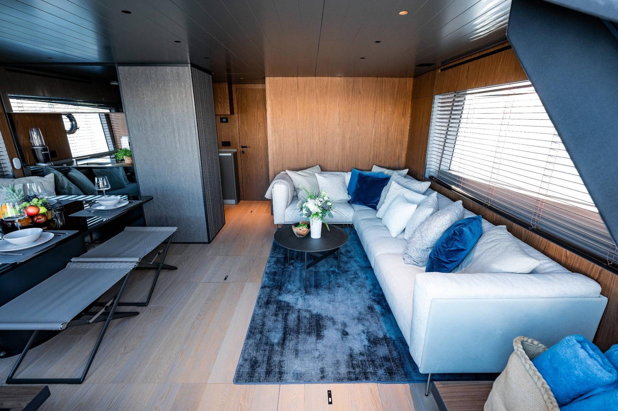 Luxurious interior of 2025 Bluegame BG74 yacht with elegant seating and dining area.