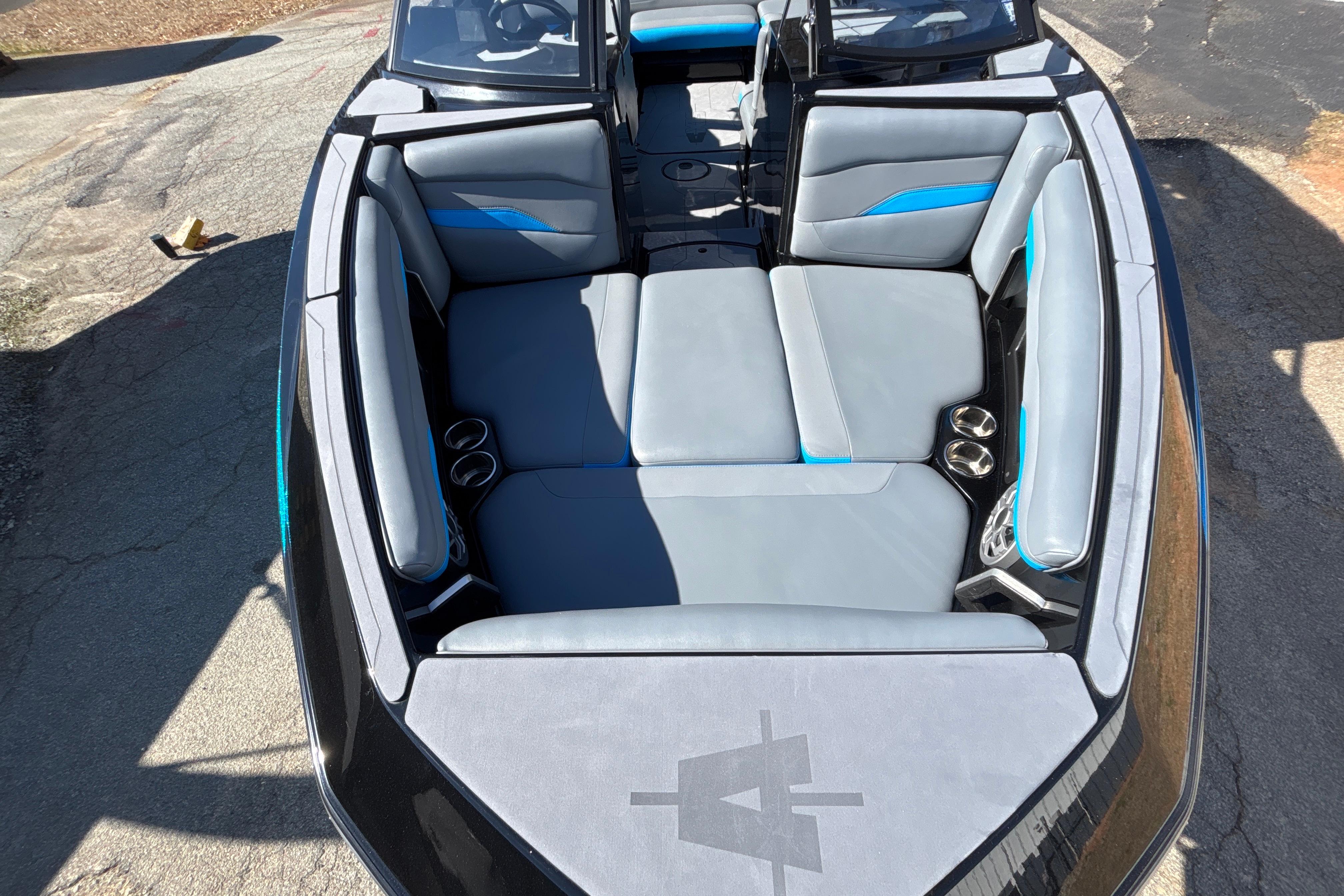 2023 Axis T220 boat interior with gray and blue seating, cup holders, and sleek design.