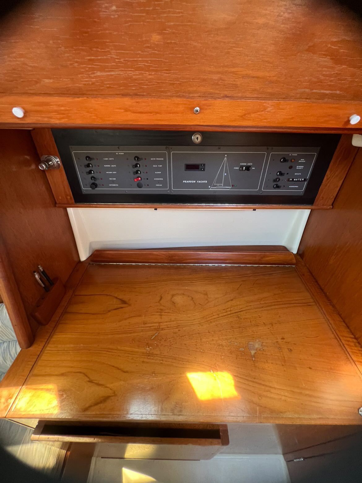 Interior view of a 1988 Pearson 28 with wood paneling and control panel.