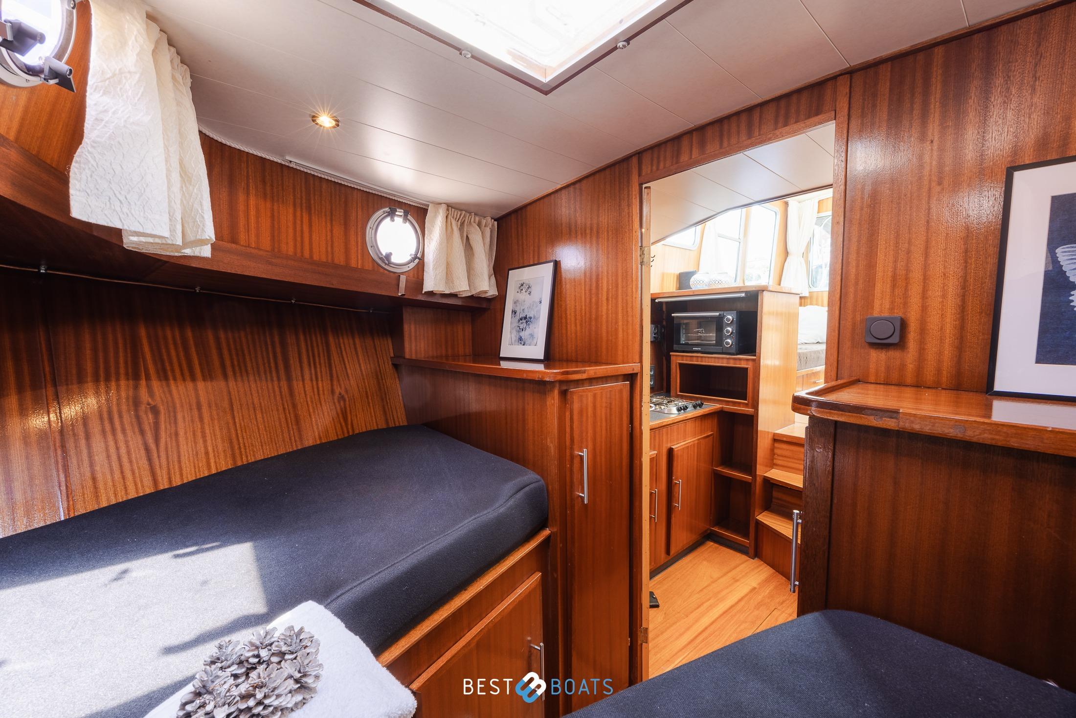 Interior of 2004 Vripack 965 OK boat with wooden finish and cozy cabin.