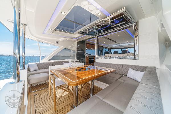Luxurious 2025 Riviera 645 SUV yacht interior with elegant seating and dining area.