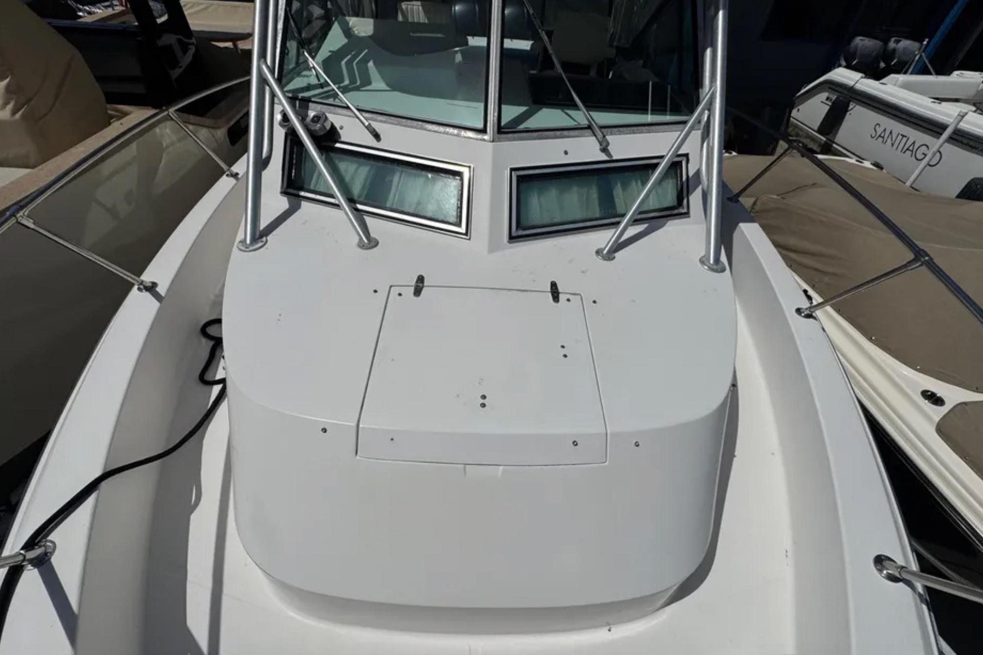 1990 Grady-White Marlin 280 boat deck with windshield and railing.