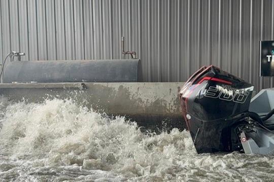 Outboard motor of 2019 Metal Shark 28 CC boat in turbulent water.