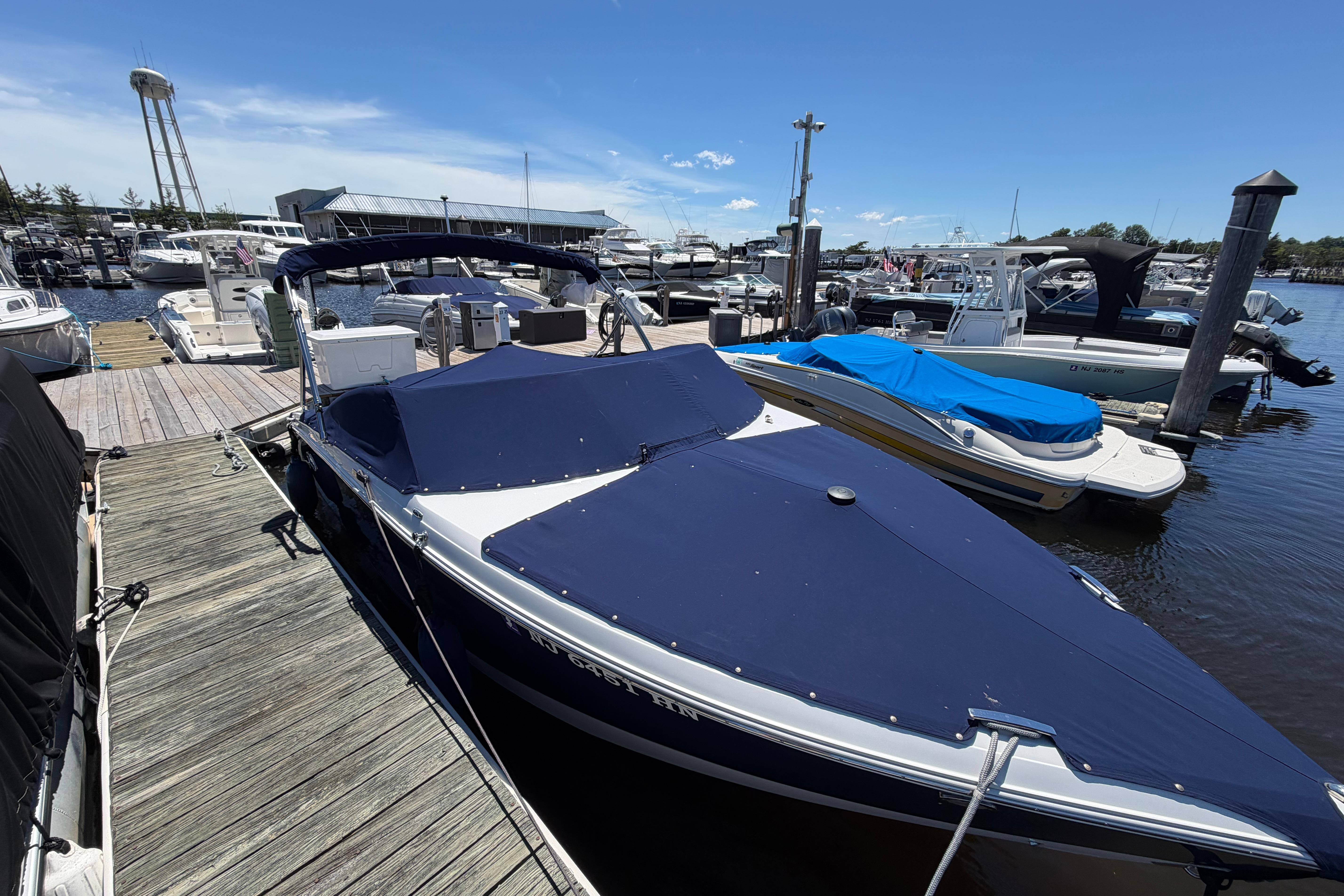 2020 Cobalt R3 boat docked at marina with blue cover.