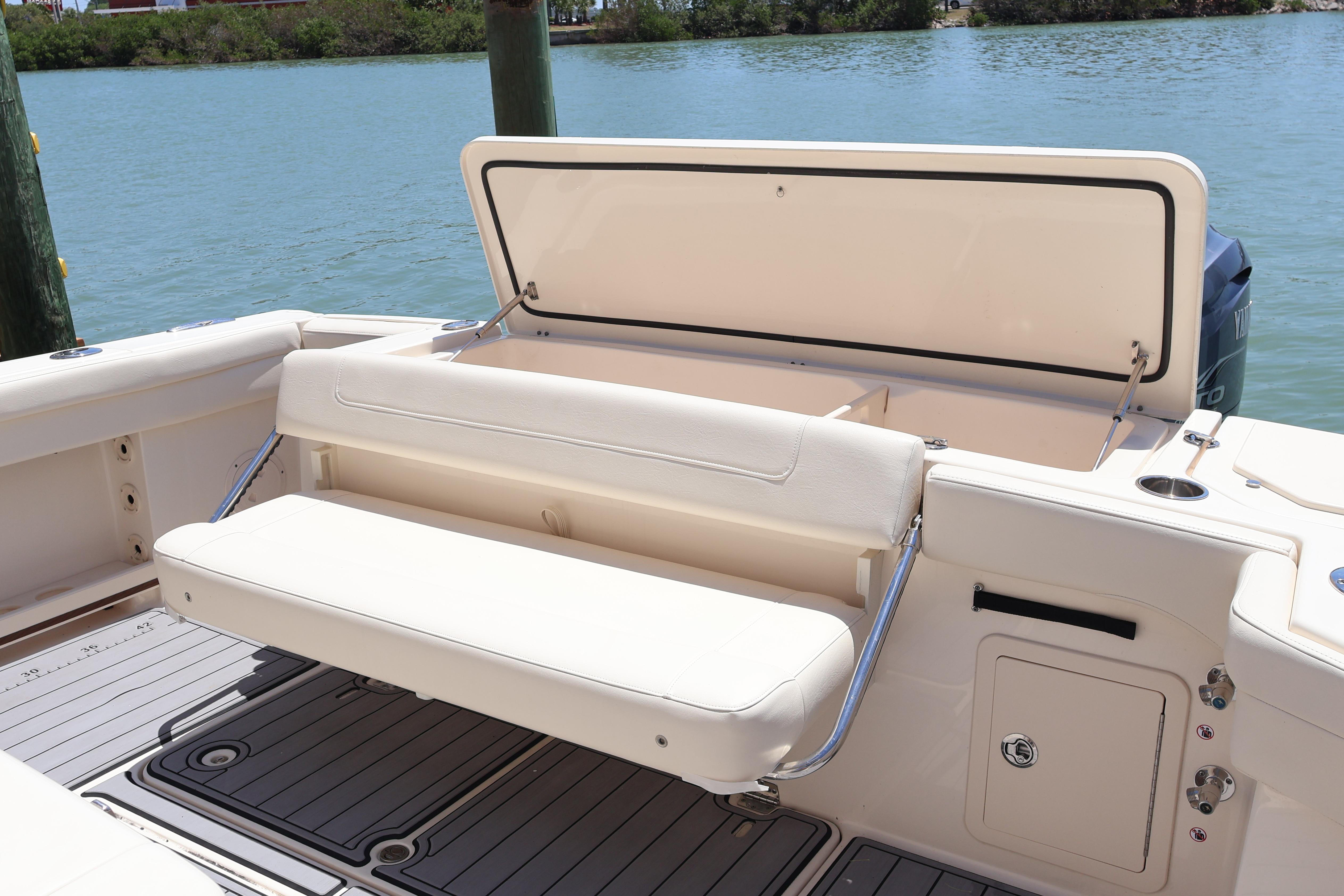 2021 Grady-White Canyon 336 boat with foldable seating and storage, docked by the water.