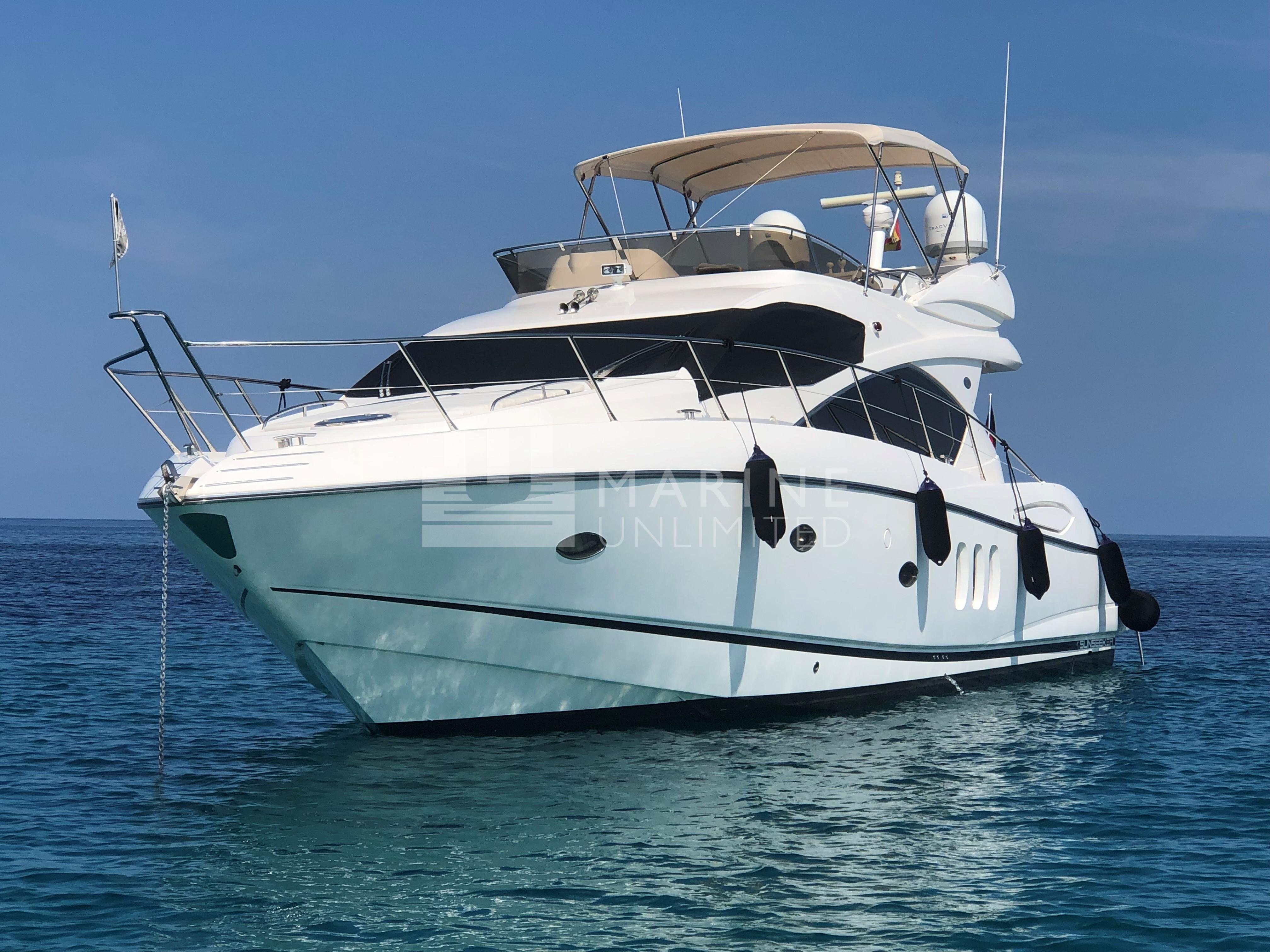 2010 Sunseeker Manhattan 52 yacht on calm blue sea.