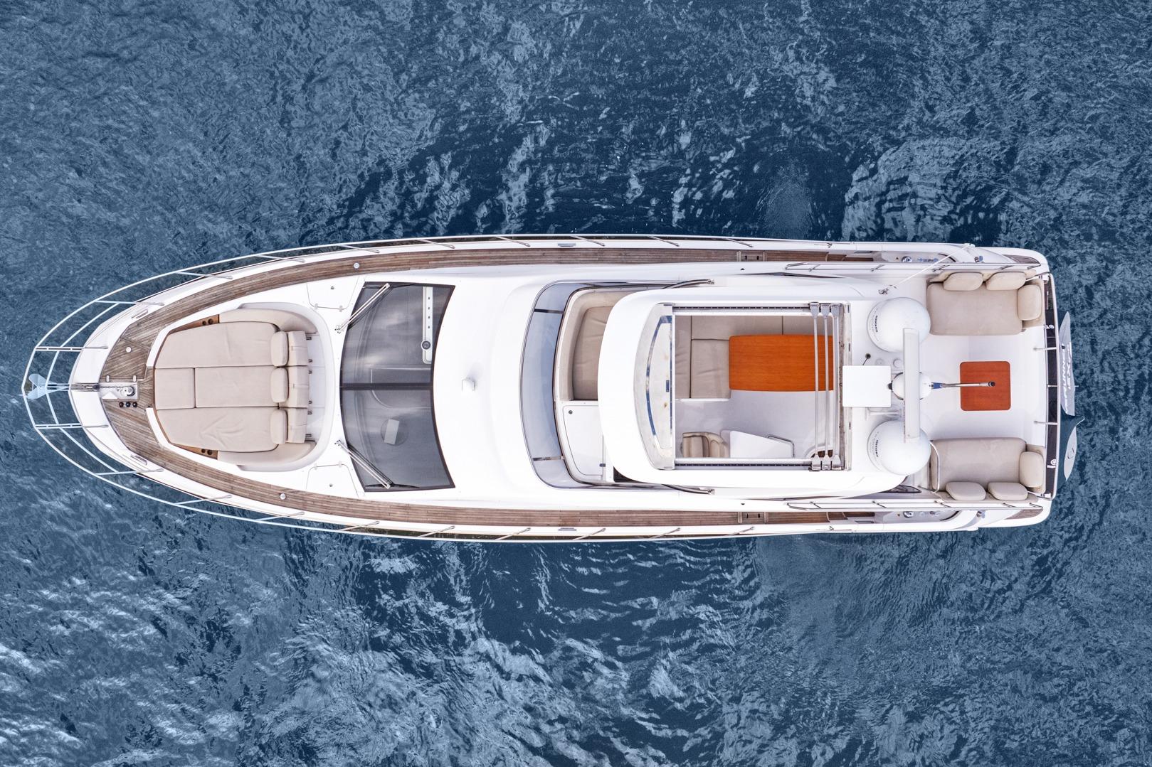 Aerial view of 2019 Azimut 55 yacht on open water, showcasing sleek design and spacious deck.