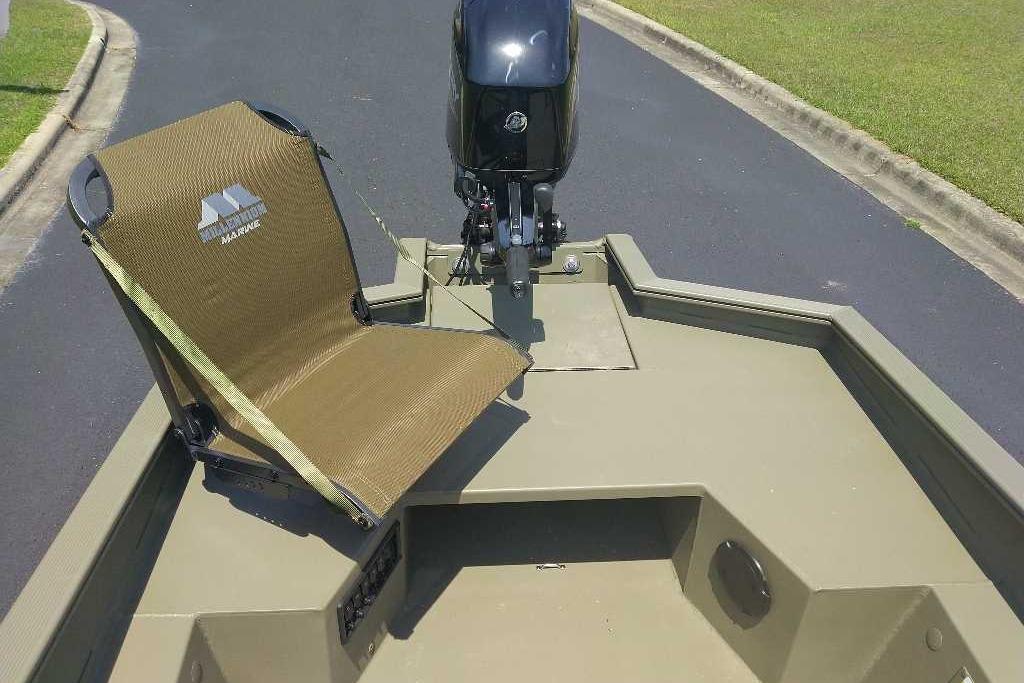 2026 Tracker Grizzly 1650 T Prairie Wings Edition boat with a mounted seat and motor.