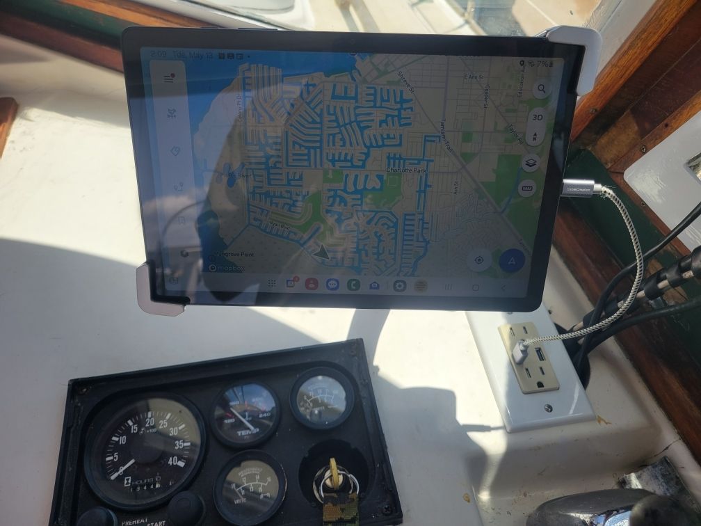 A navigation system and instruments on a boat with a map displayed on the screen.