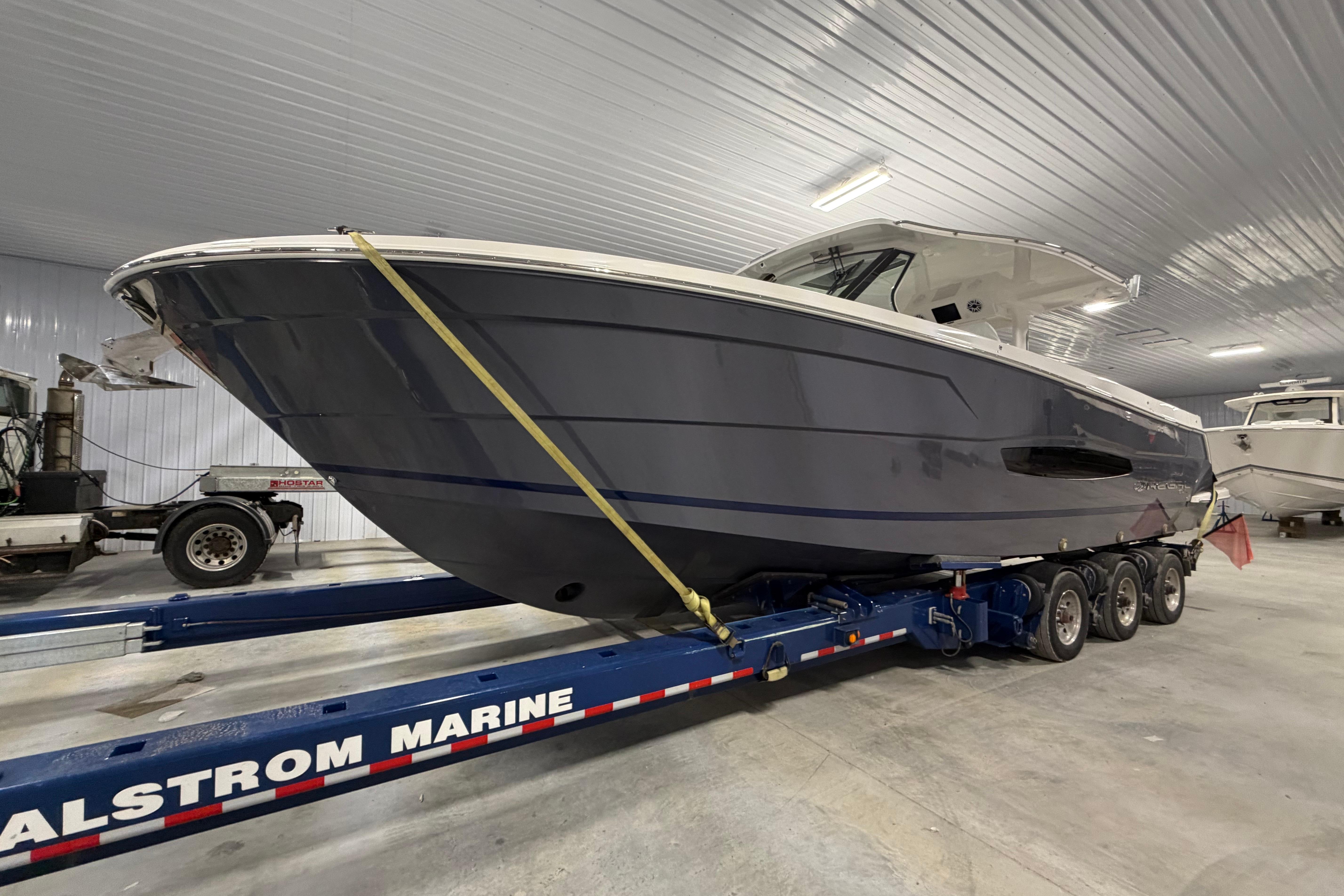 2027 Regal 38 Surf boat on trailer in indoor storage facility.