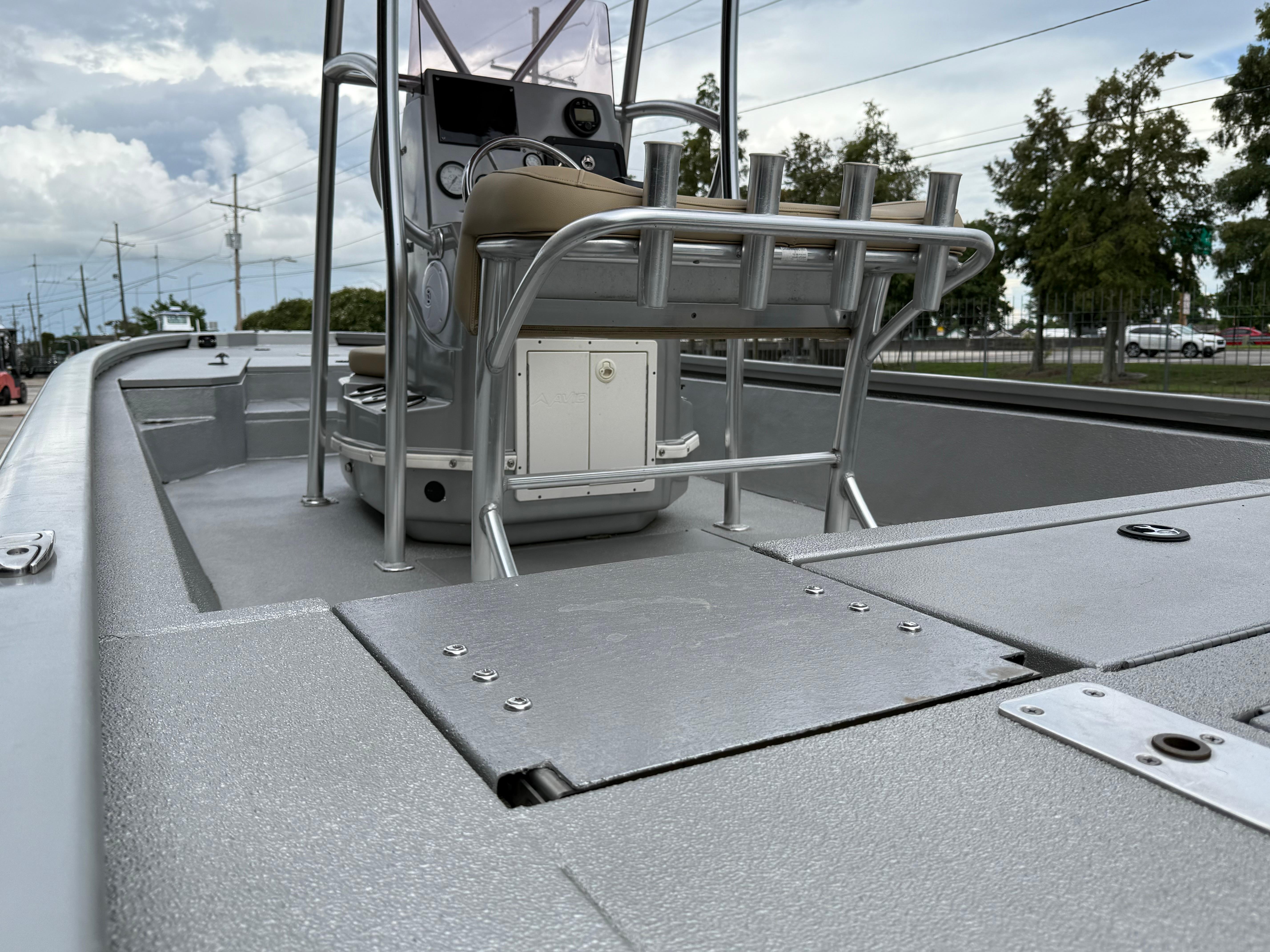 2020 Avid 23 FS Platinum boat interior with console and seating, under a cloudy sky.