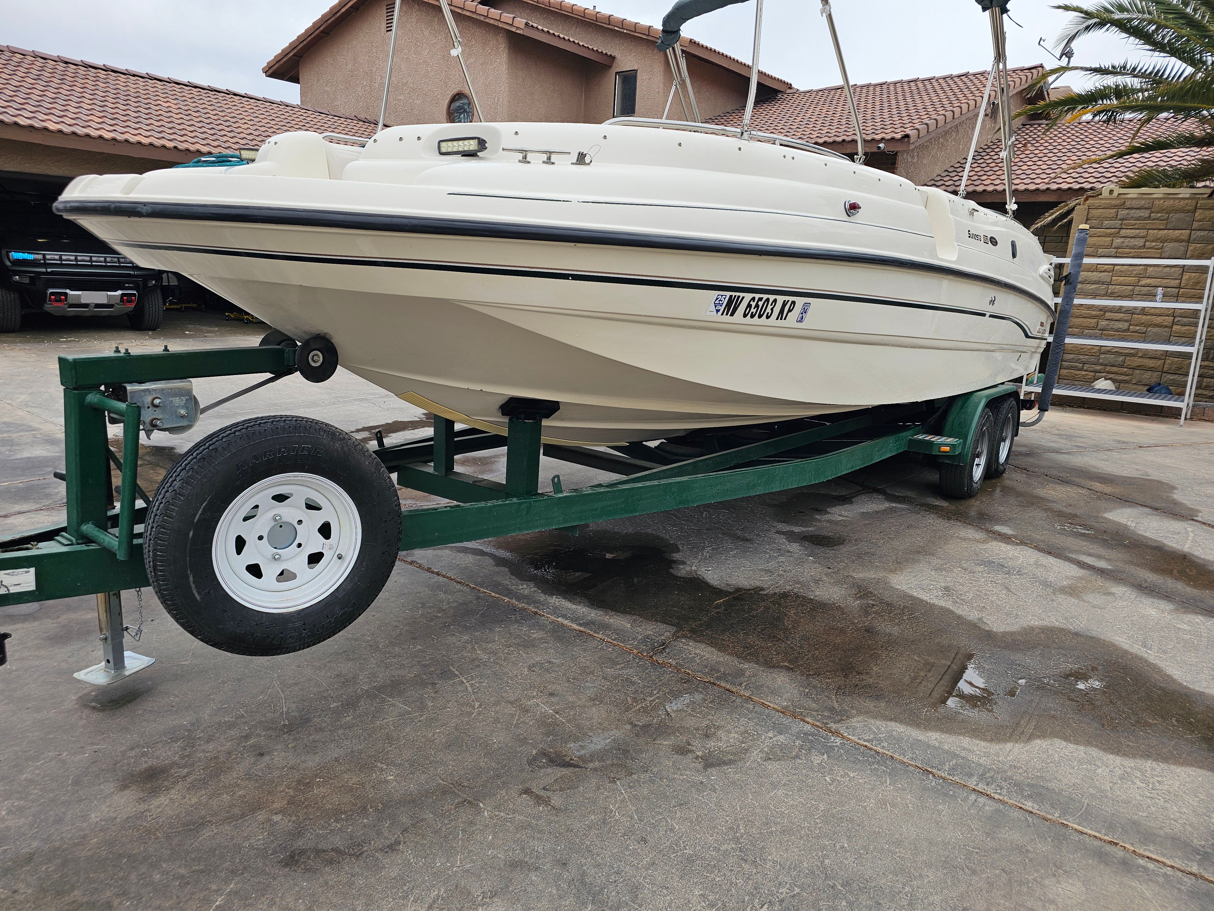 1998 Chaparral Sunesta 252 Special Edition on trailer in driveway.