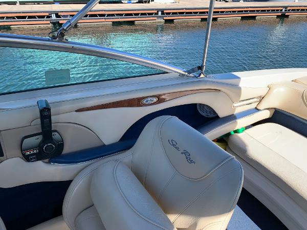 Interior of a 2000 Sea Ray 210 Bow Rider boat with cream leather seats.