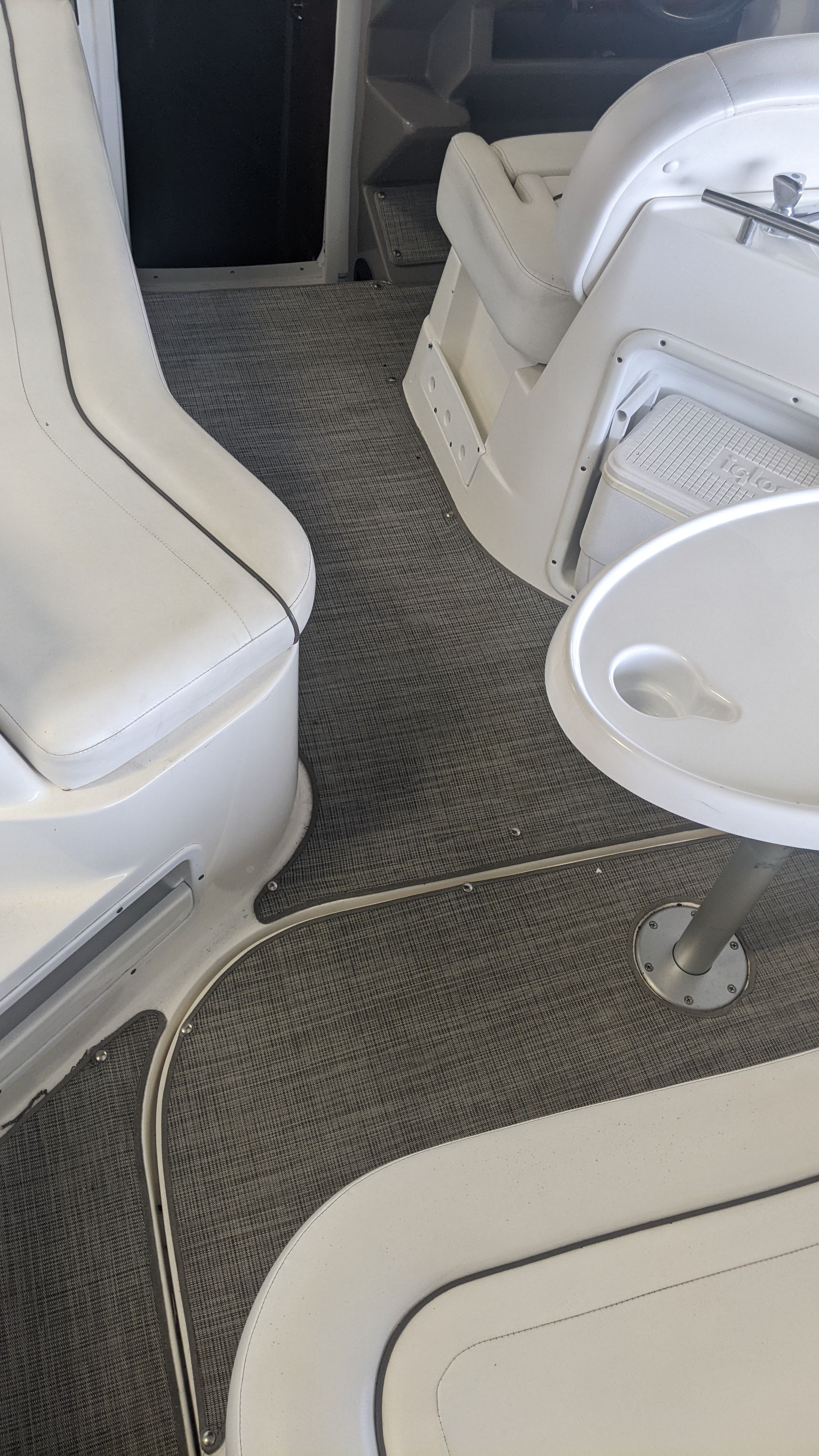 Interior of a 2006 Rinker 250 EC boat with white seating.