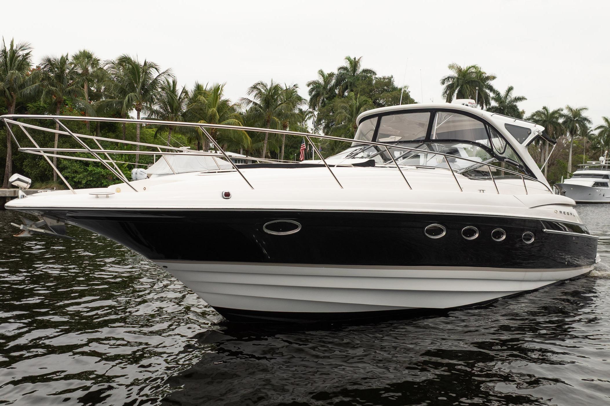2008 Regal Commodore 4460 yacht on water, surrounded by palm trees.