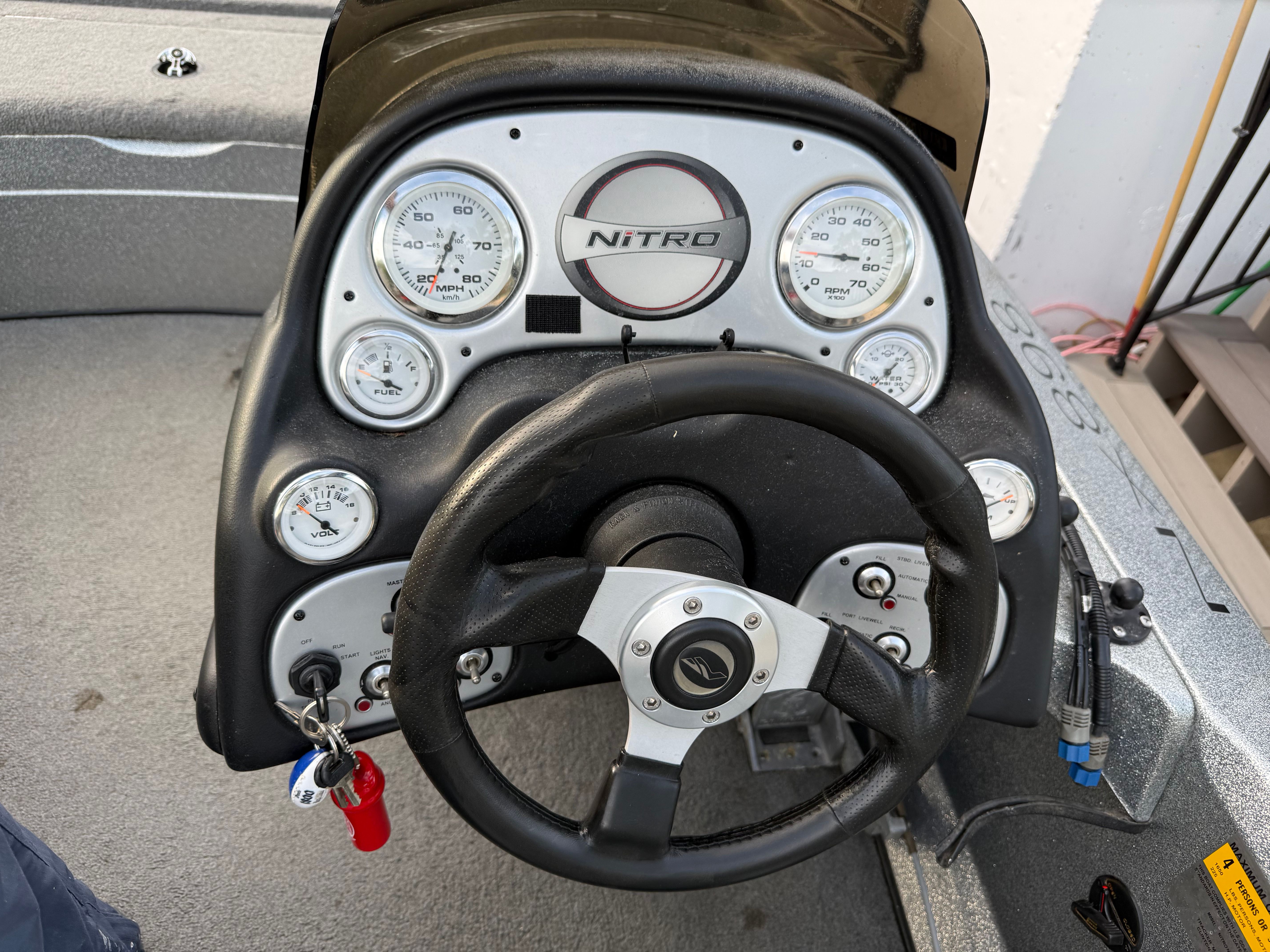 Dashboard of a 2004 Nitro NX 898 DC boat with steering wheel.