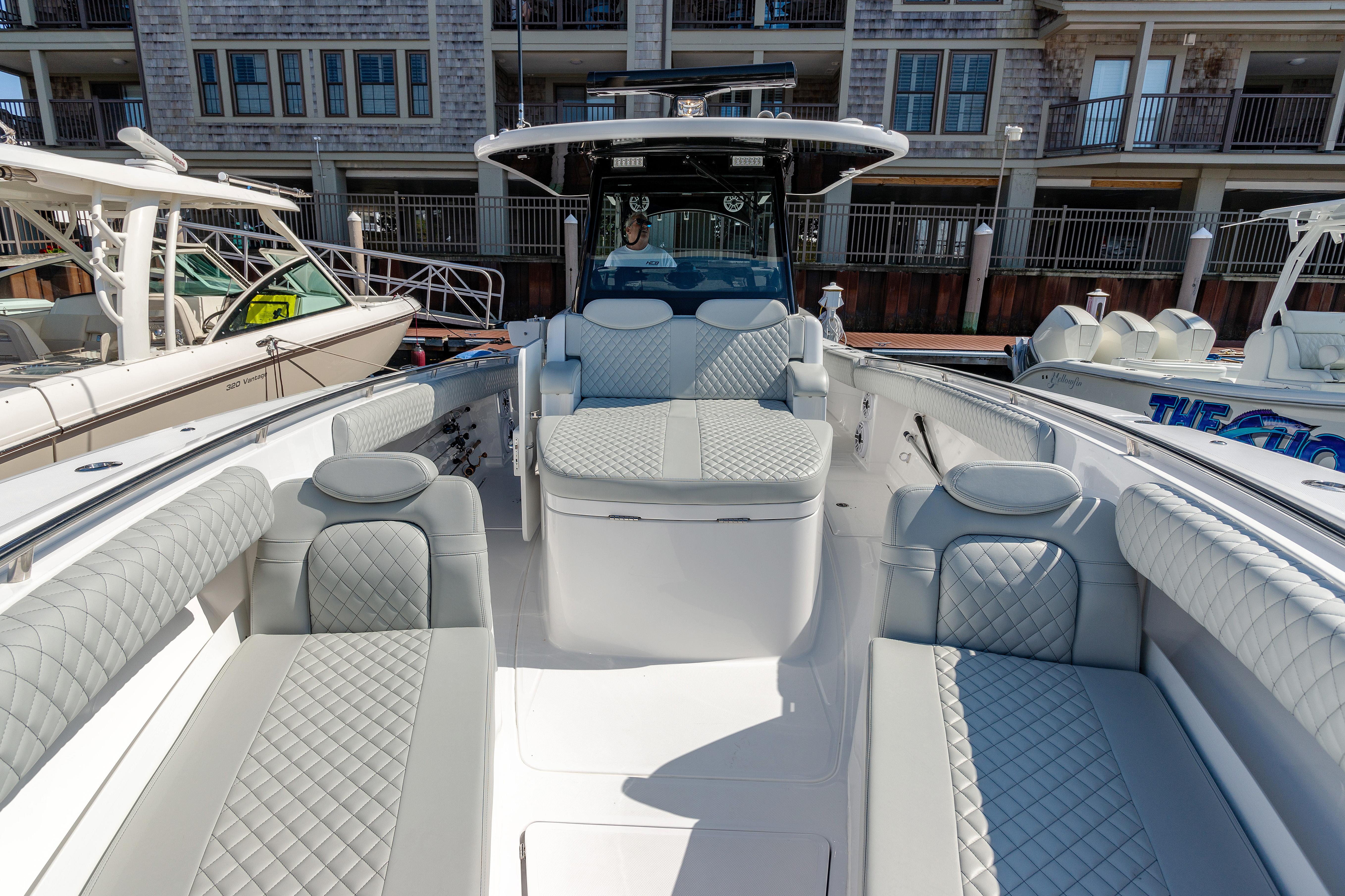 2024 HCB 39 Speciale luxury boat interior with quilted seating at a marina.