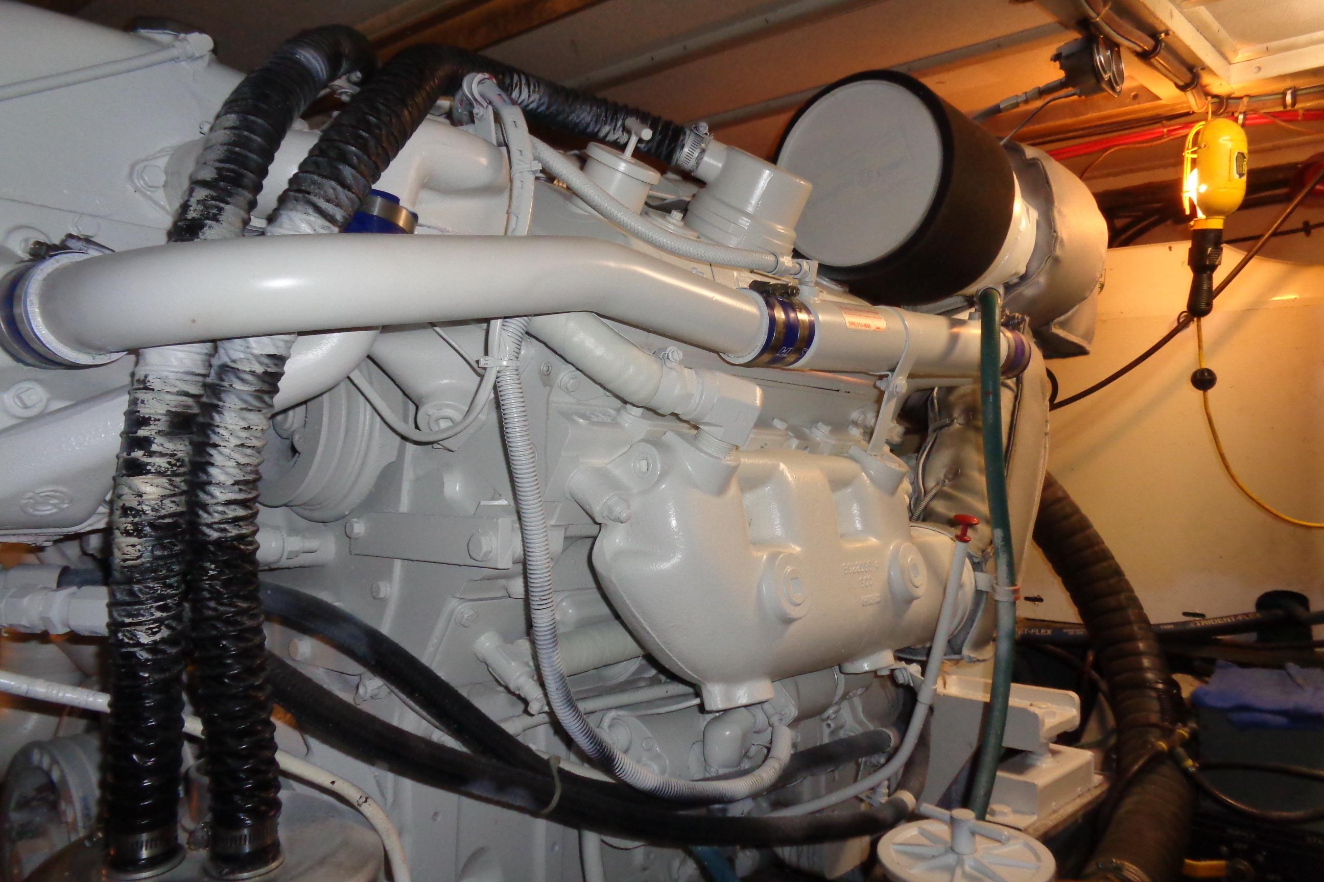 Engine room of 1981 Hatteras 48 Cockpit Motor Yacht, showcasing detailed machinery components.