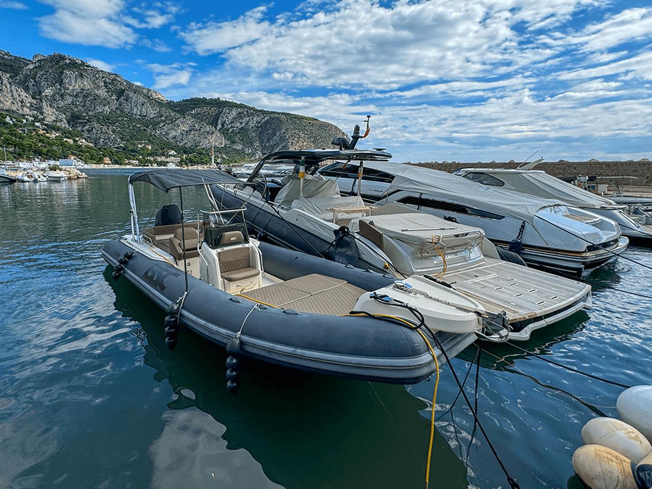 BSC 78 boat docked in scenic marina with mountains and cloudy sky, 2019 model.