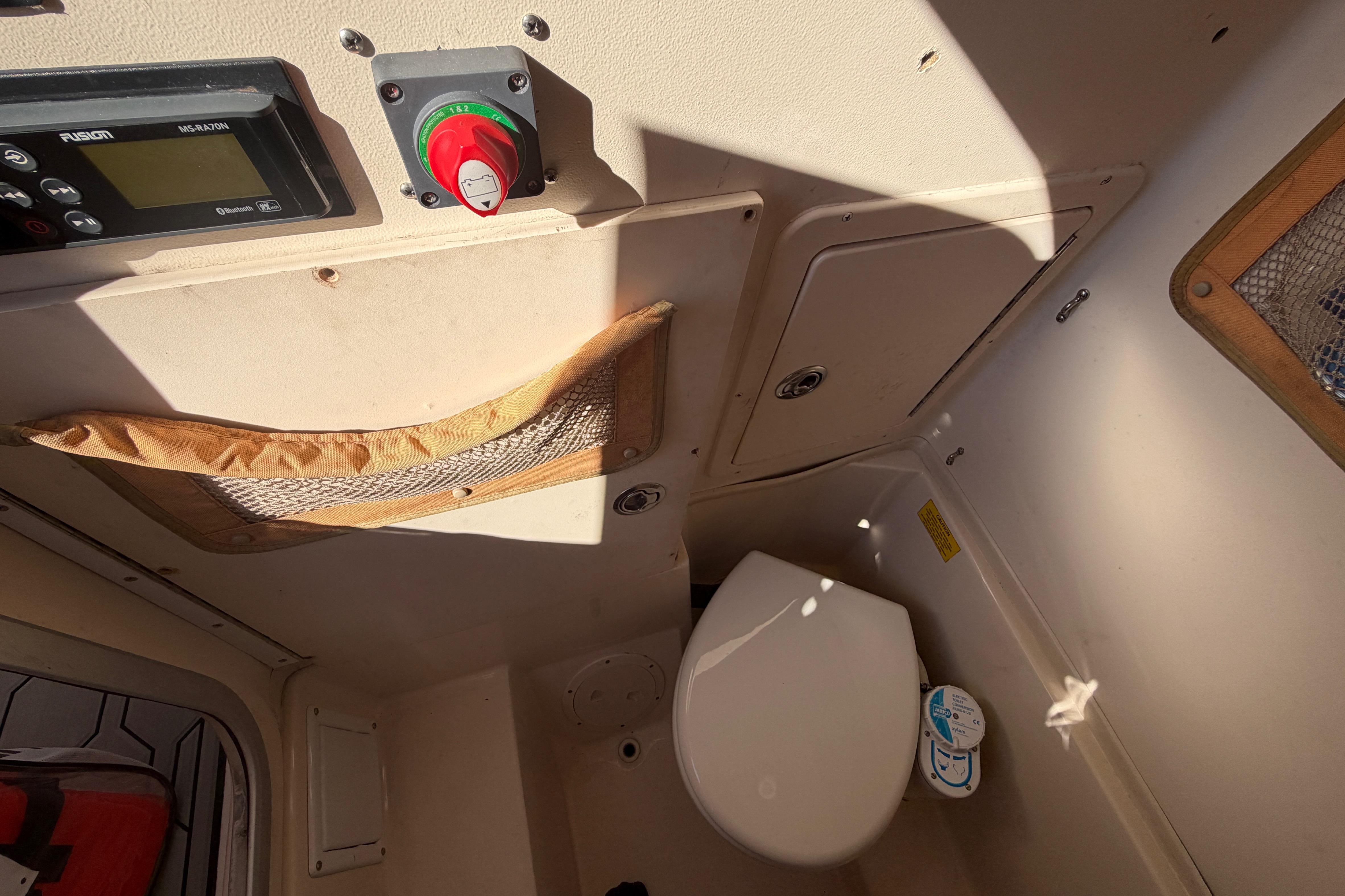 Interior of 2004 Grady White 273 boat with toilet and control panel.