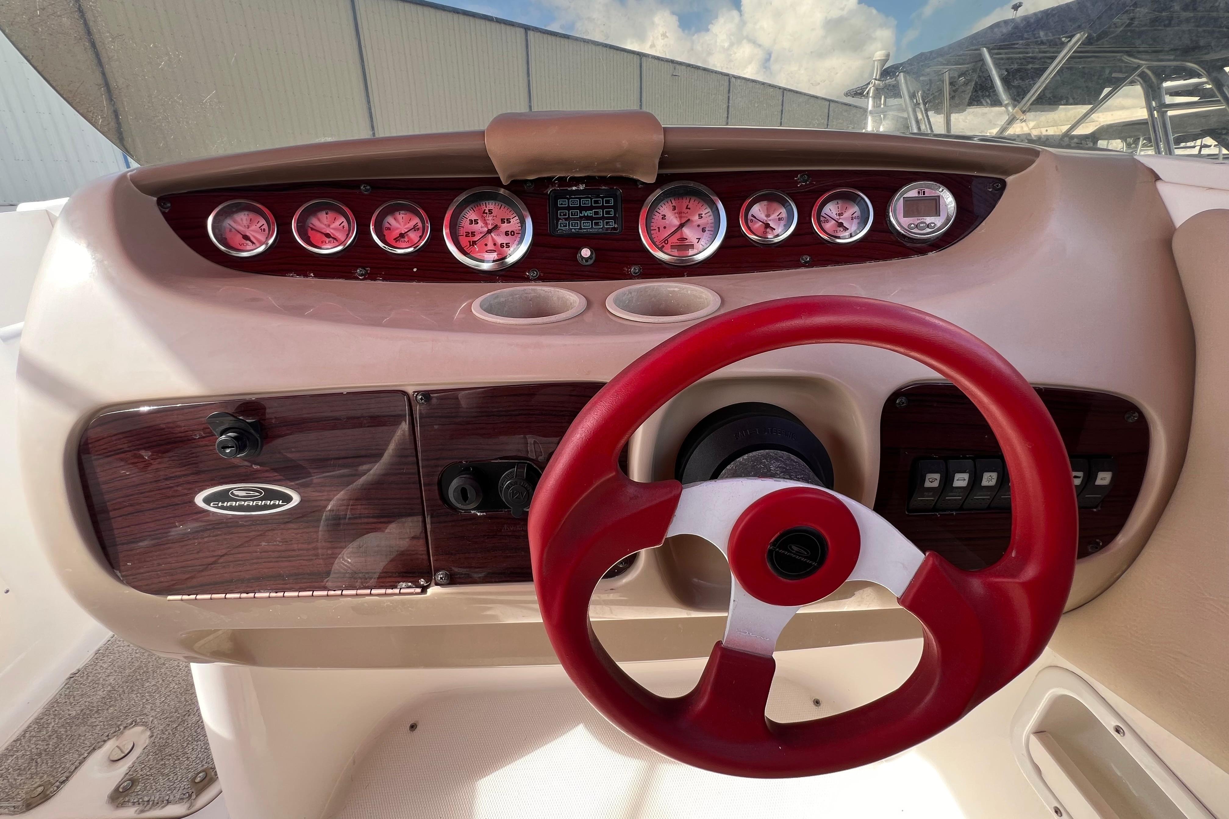 2002 Chaparral 232 Sunesta dashboard with red steering wheel and gauges.