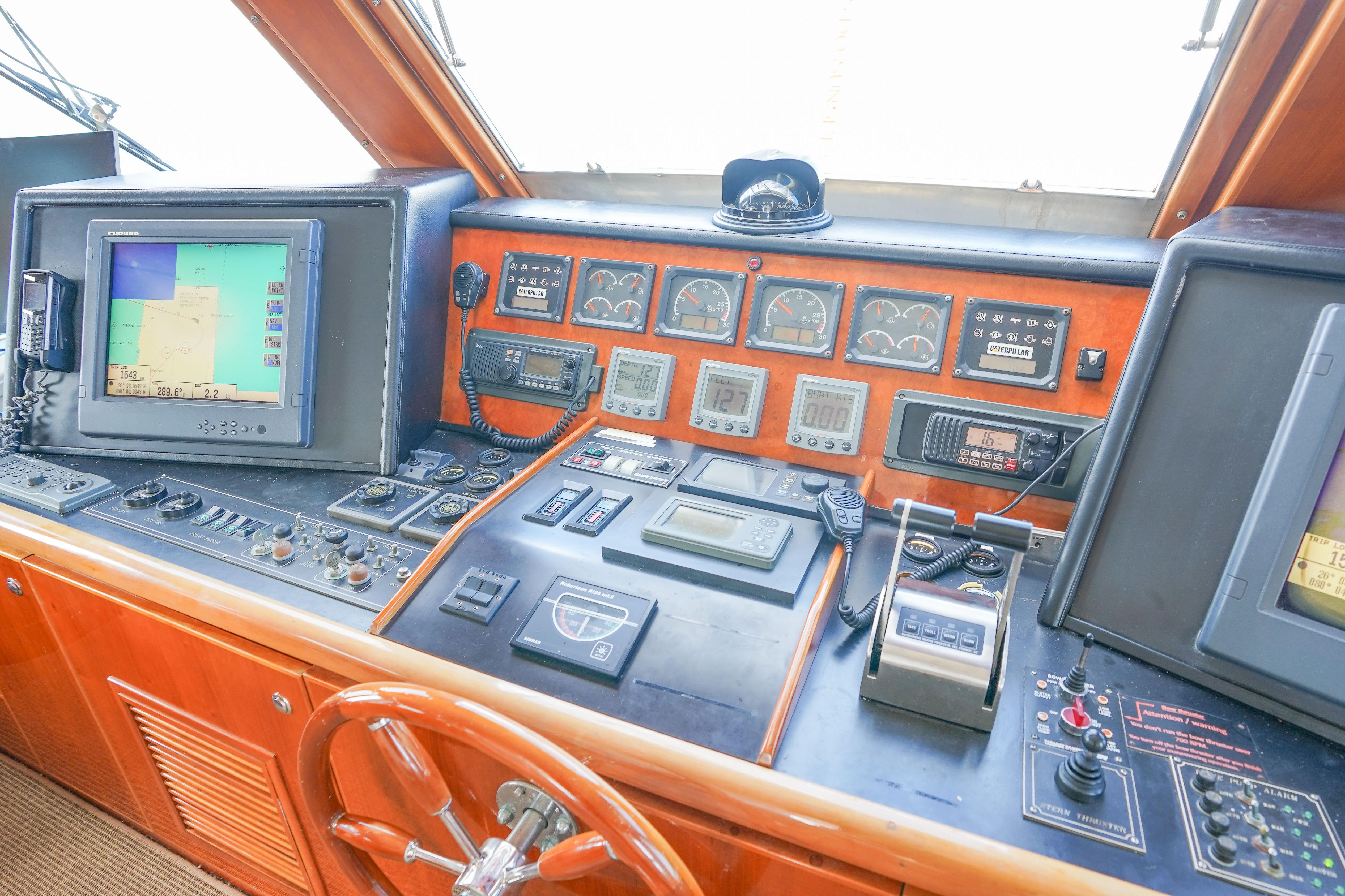 Control panel of a 2001 Monte Fino 82MY yacht with navigation equipment and gauges.