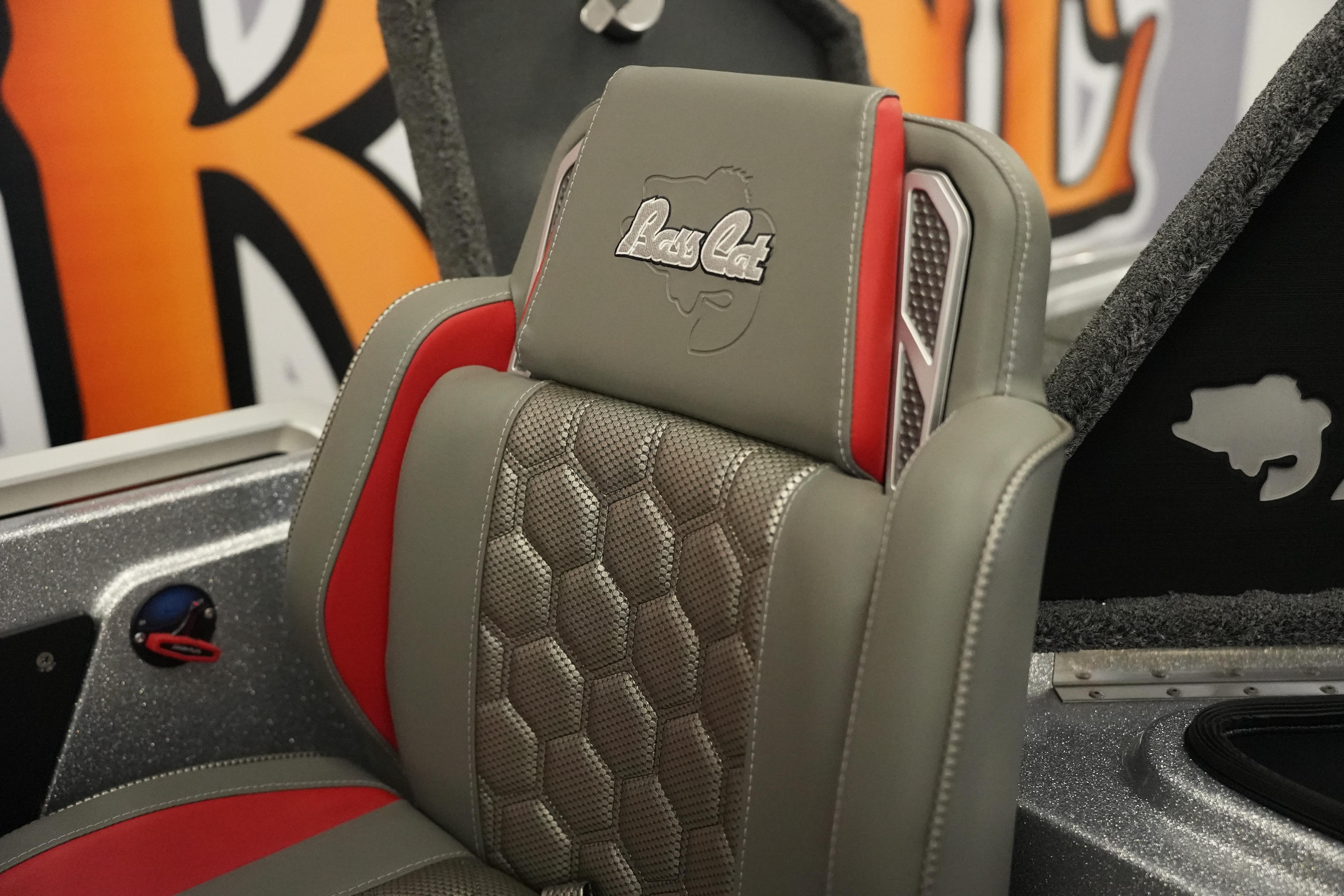 2026 Bass Cat Lynx STS boat seat with gray and red upholstery, featuring logo embroidery.