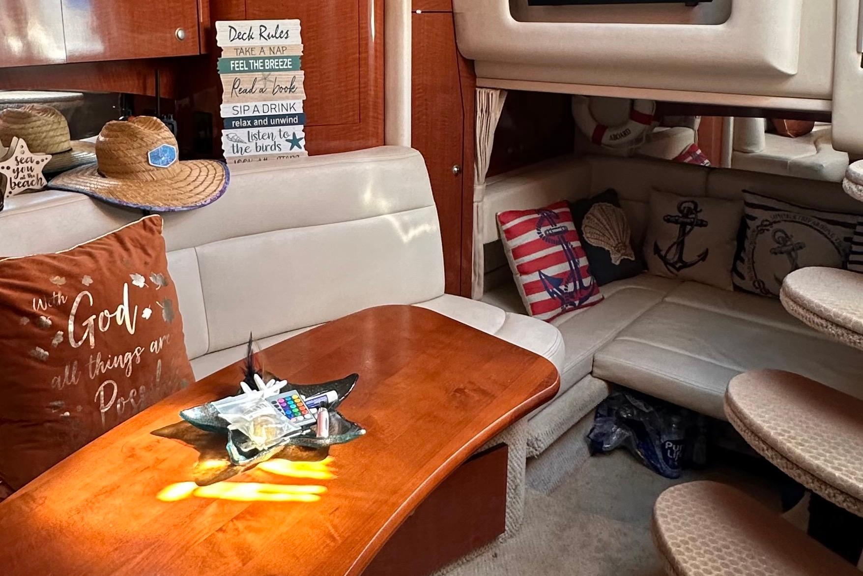Interior of 2005 Sea Ray 320 Sundancer with nautical decor and cozy seating area.