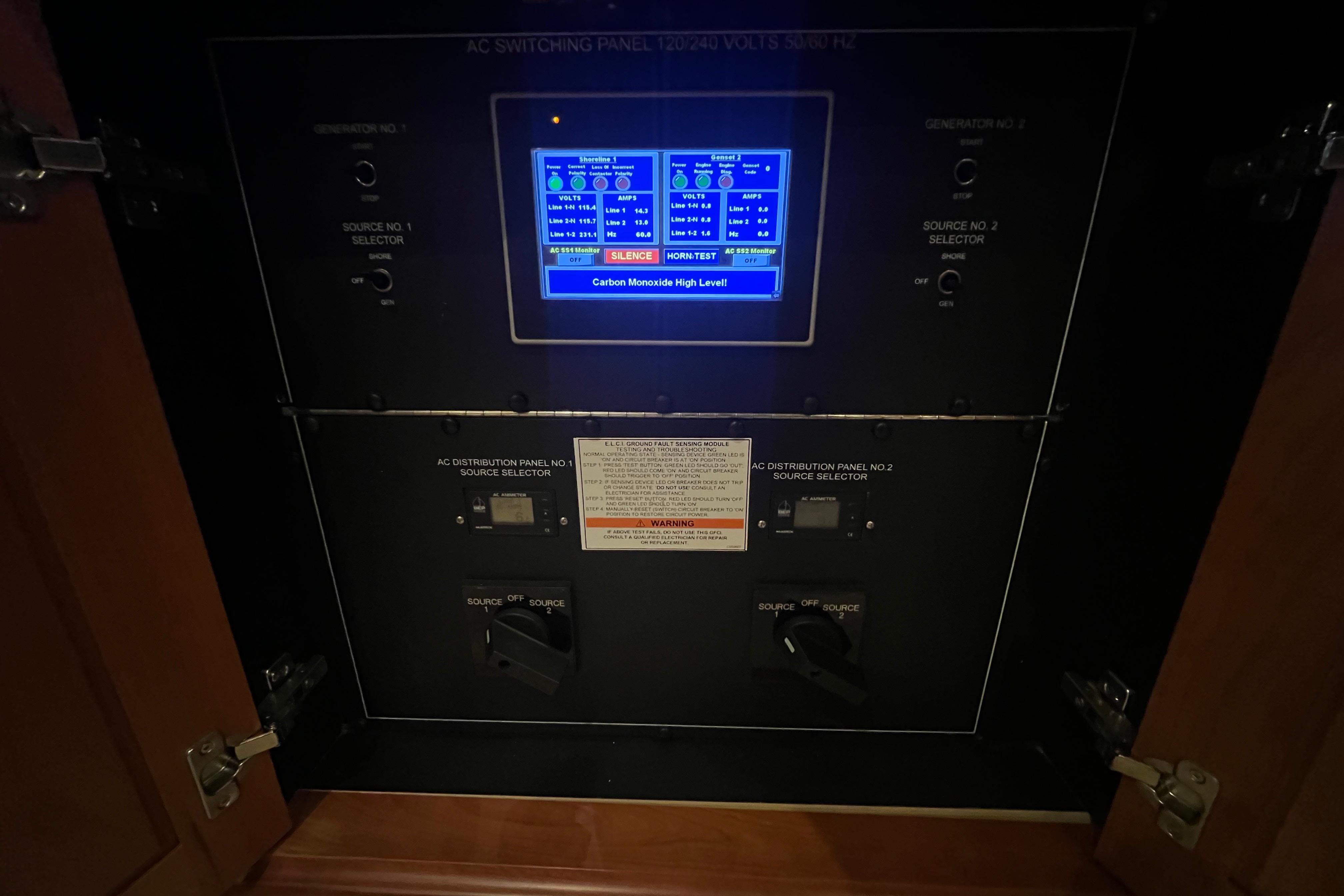 Electrical control panel on a 2013 Hatteras GT63 yacht, displaying carbon monoxide alert.