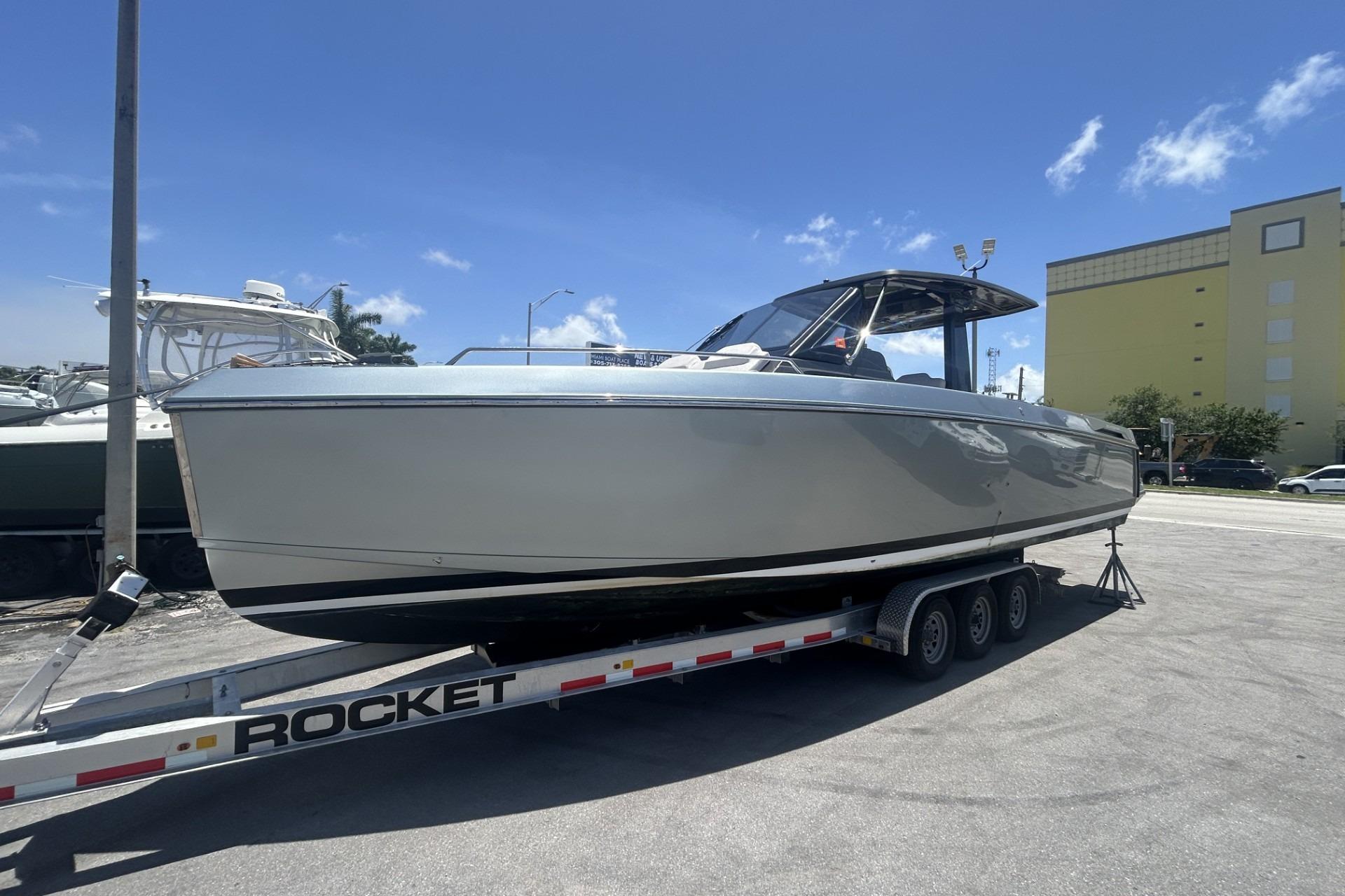 2023 Schaefer V33 boat on a trailer under a clear blue sky.
