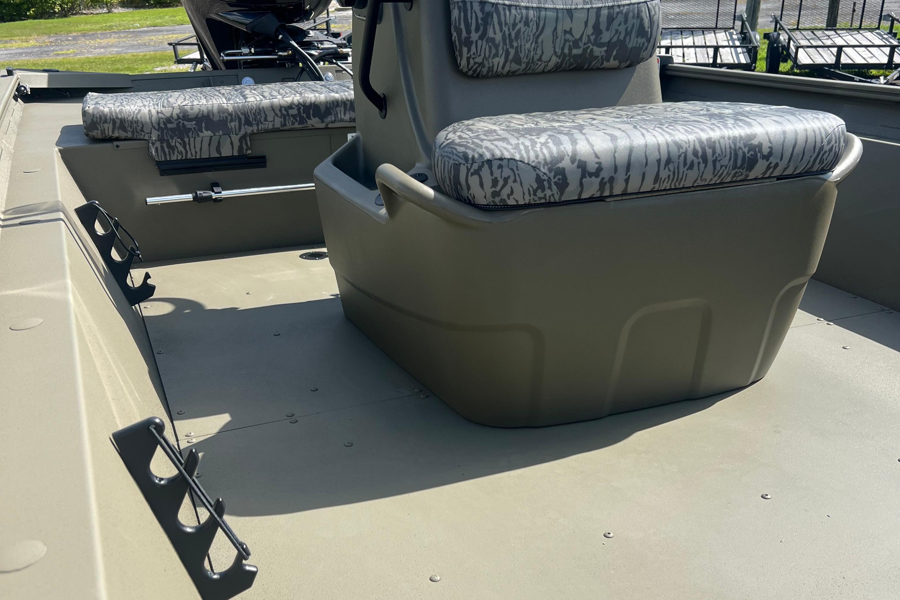 2026 Tracker Grizzly 1860 CC boat interior with camouflage seating and storage compartments.