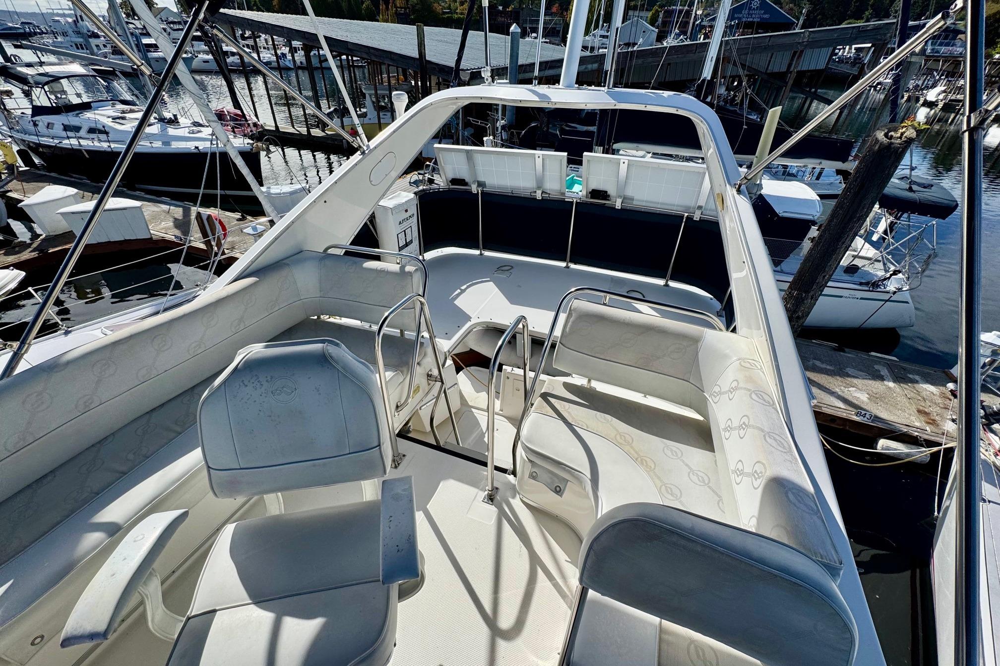 1998 Bayliner 3388 Command Bridge Motoryacht interior with seating, docked at marina.
