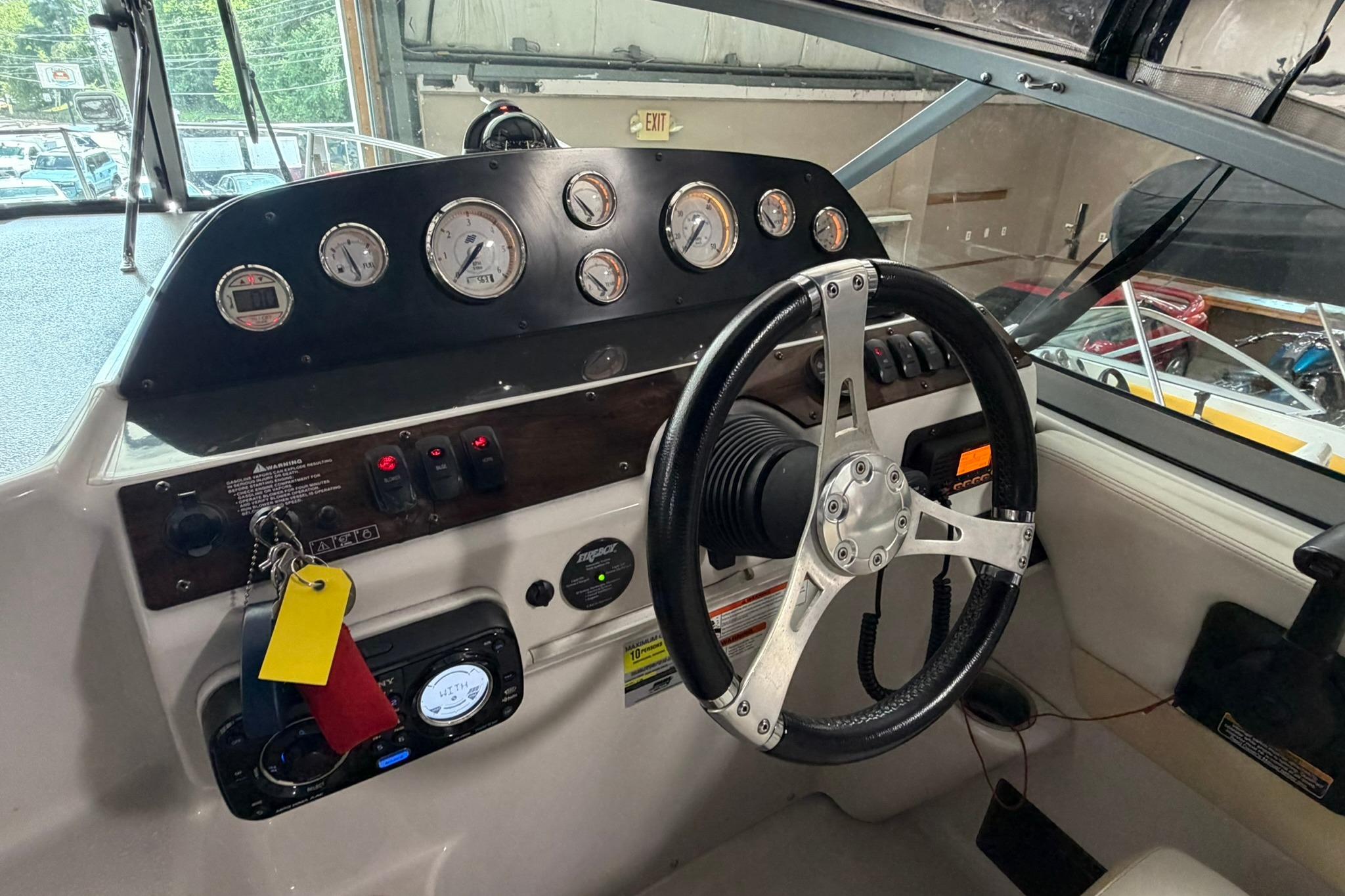 2008 Four Winns V248 boat dashboard with steering wheel and instrument panel.