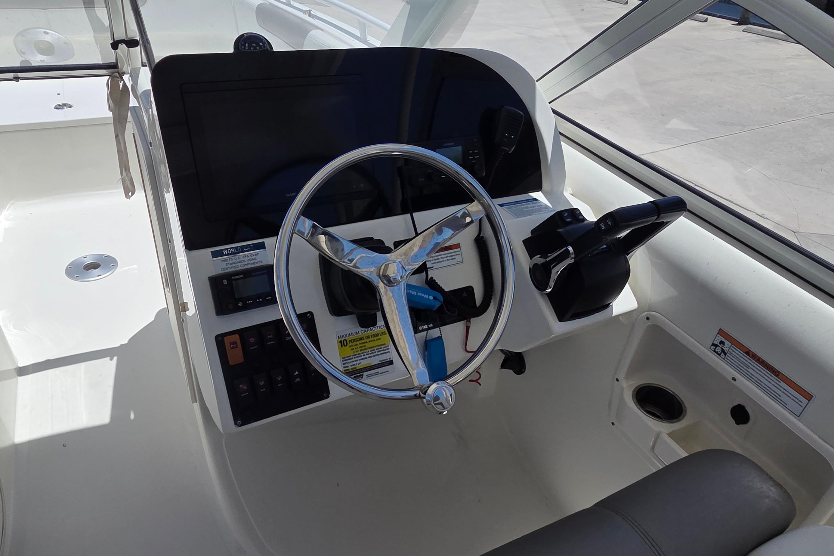 Helm of 2022 World Cat 255 DC boat with steering wheel and controls.