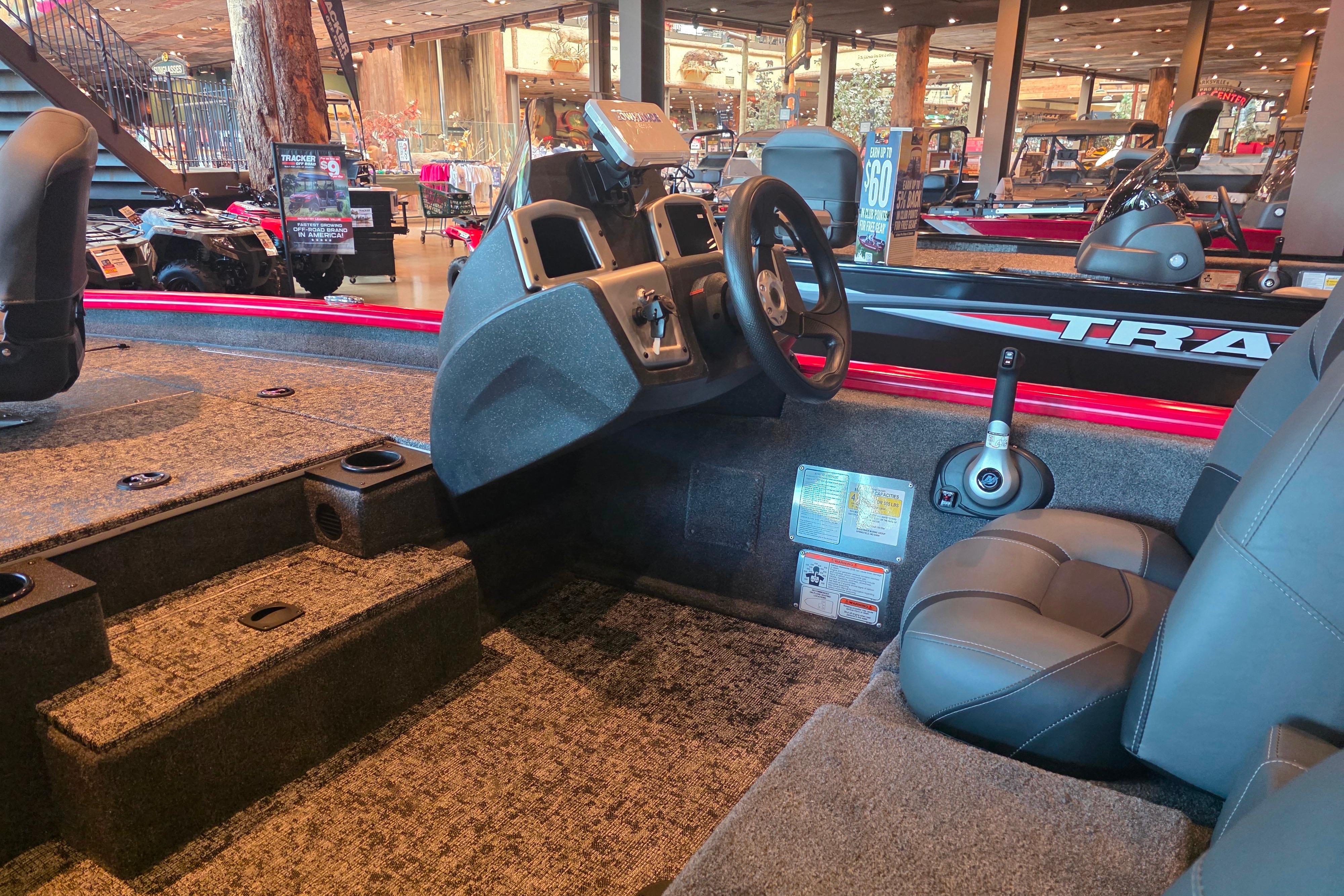 Interior of a 2026 Tracker Pro Team 175 boat, showcasing steering and seating.