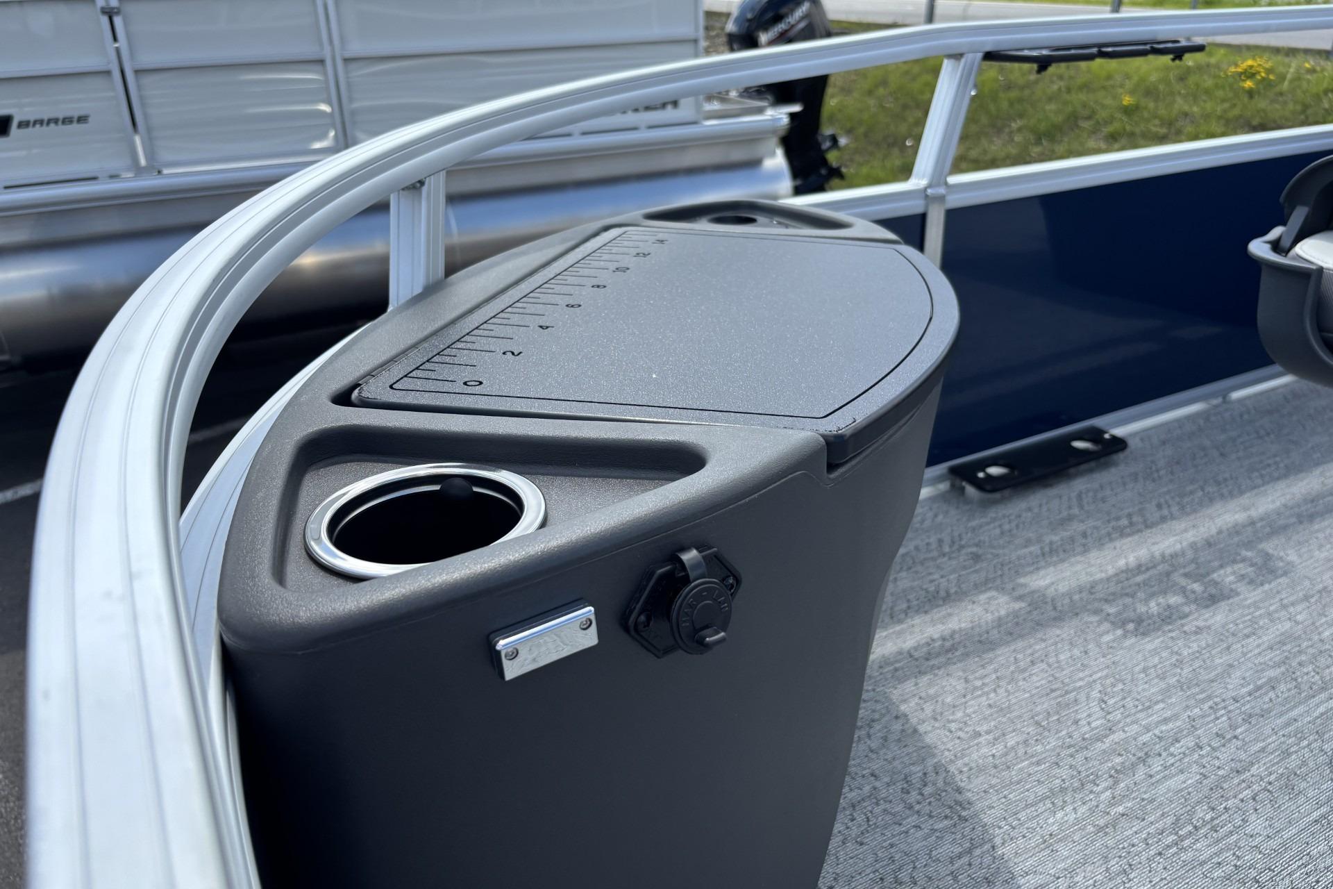 2026 Sun Tracker Bass Buggy 18 DLX boat console with cup holder and measurement markings.