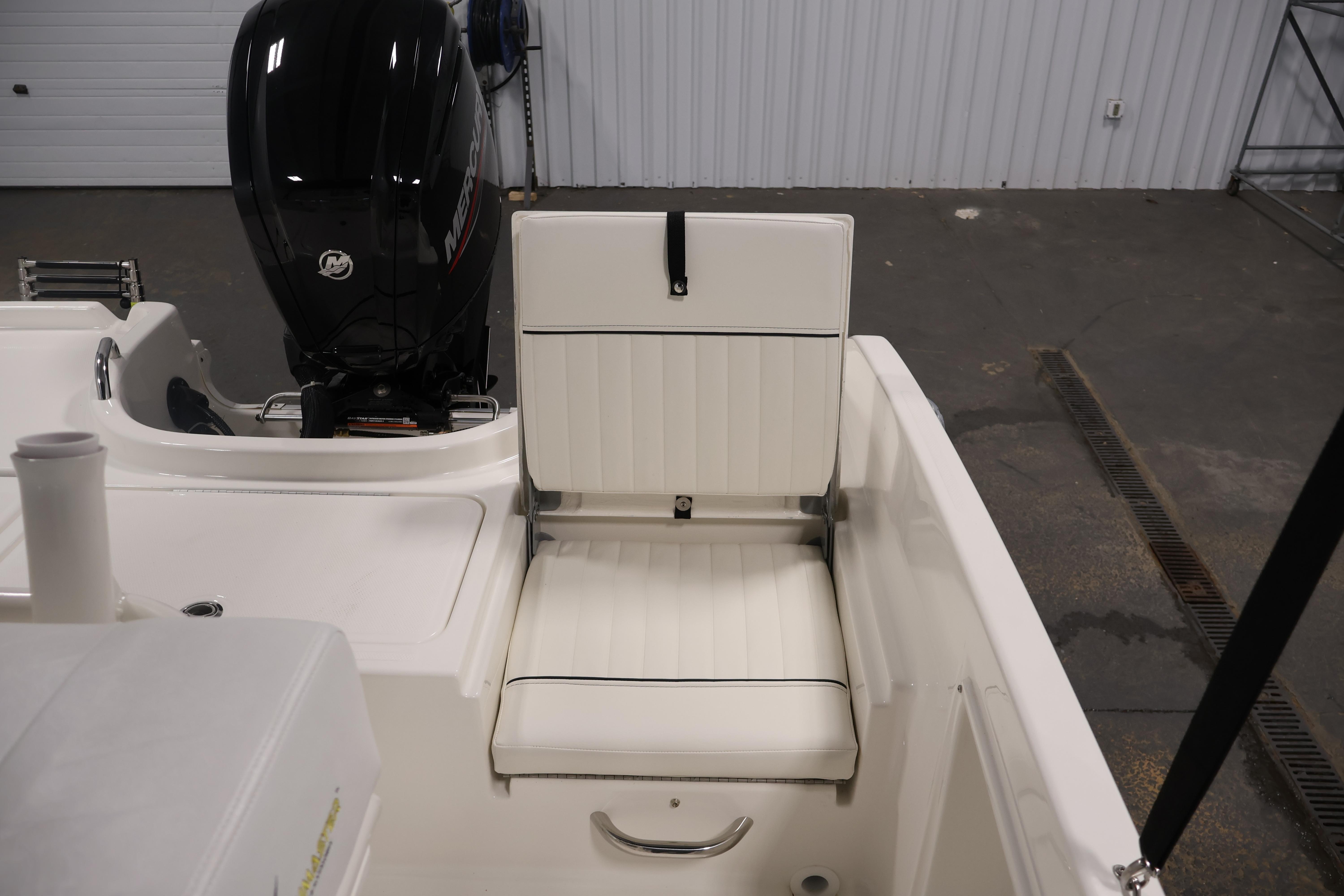2026 Bayliner Trophy T18 boat interior with white seating and Mercury outboard motor.