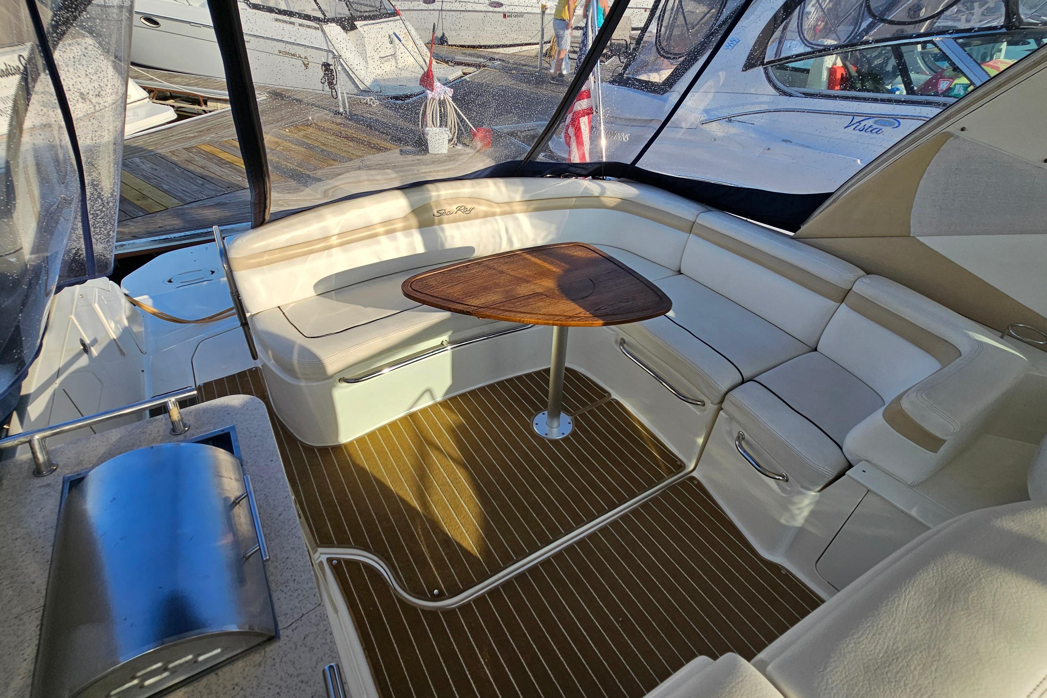 2008 Sea Ray Sundancer 350 interior with elegant seating and wooden table.