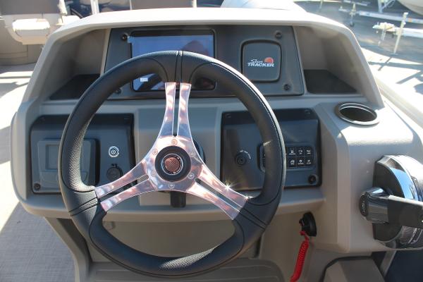 2025 Sun Tracker Fishin' Barge 22 DLX steering console with modern controls and display.