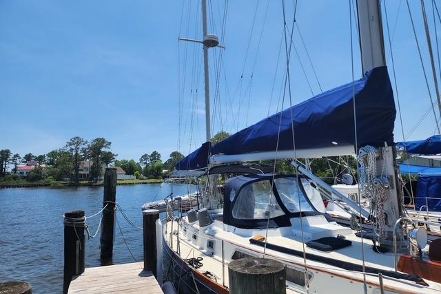 1984 Bristol 45.5 Center Cockpit sailboat docked by a serene waterfront.