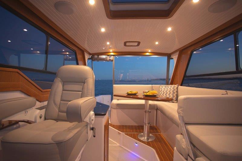 Luxurious interior of 2024 True North 34 yacht with elegant seating and ambient lighting.