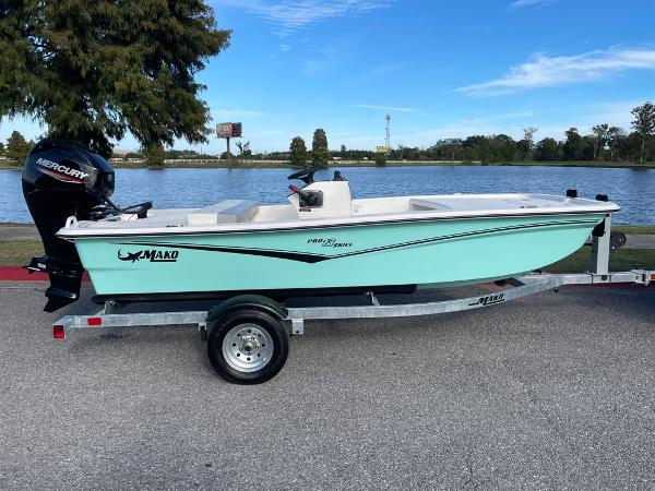 2024 Mako Pro Skiff 13 CC boat on trailer by a lake.