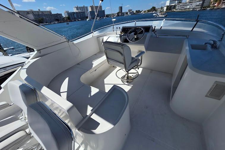 1993 McKinna 48 Pilothouse yacht interior with helm, seating, and waterfront view.