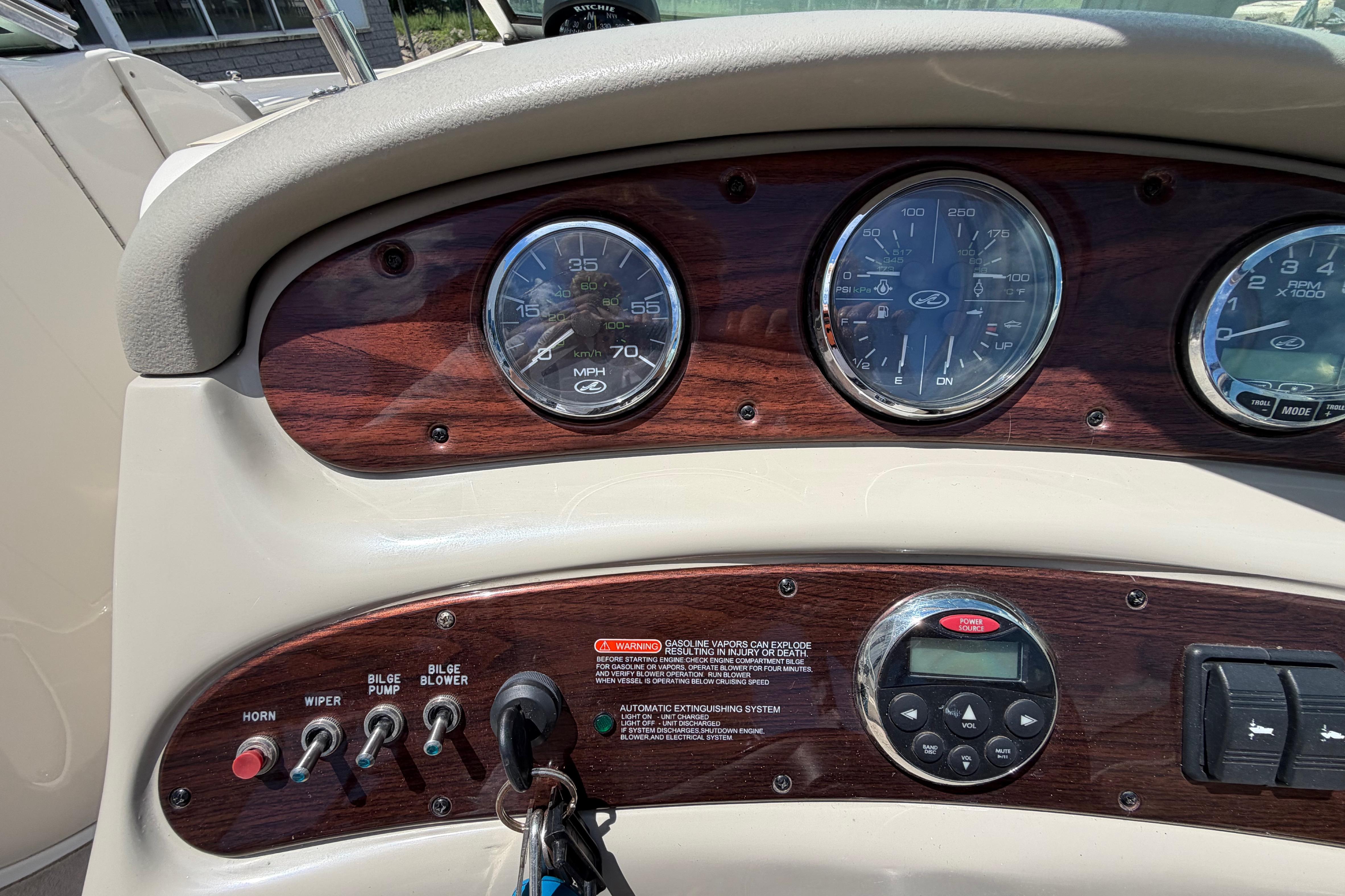 Dashboard of a 2004 Sea Ray 240 Sundeck boat with gauges and controls.